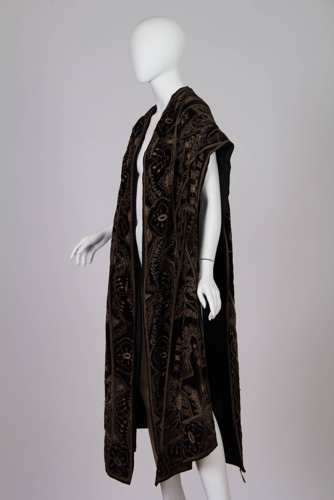 This is an absolutely stunning Edwardian mantle of cotton velvet with silver metalwork embroidery. The likeliest dates for this piece fall in the second decade of the 20th century, as silhouettes straightened and edged closer to the square lines of