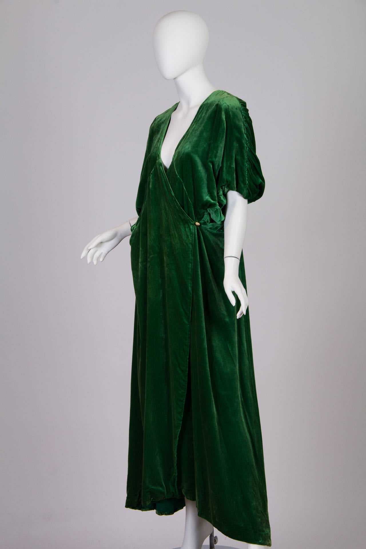 This ankle-length peignoir is the height of luxury loungewear from the opulent Edwardian era. Most likely dating from around 1912, this is the sort of robe which a lady might have pulled about herself while reading before bed in her suite on the