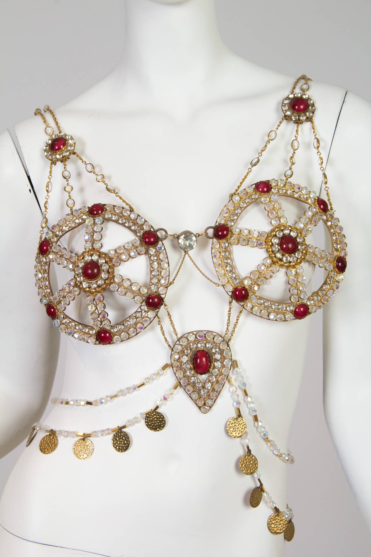 This is a striking body chain from between the 1880s and the 1940s, most likely dating to around 100 to 1915. A fancy-dress (costume) piece, it was inspired by romanticized European conceptions of the Middle East and India. Actresses and models of