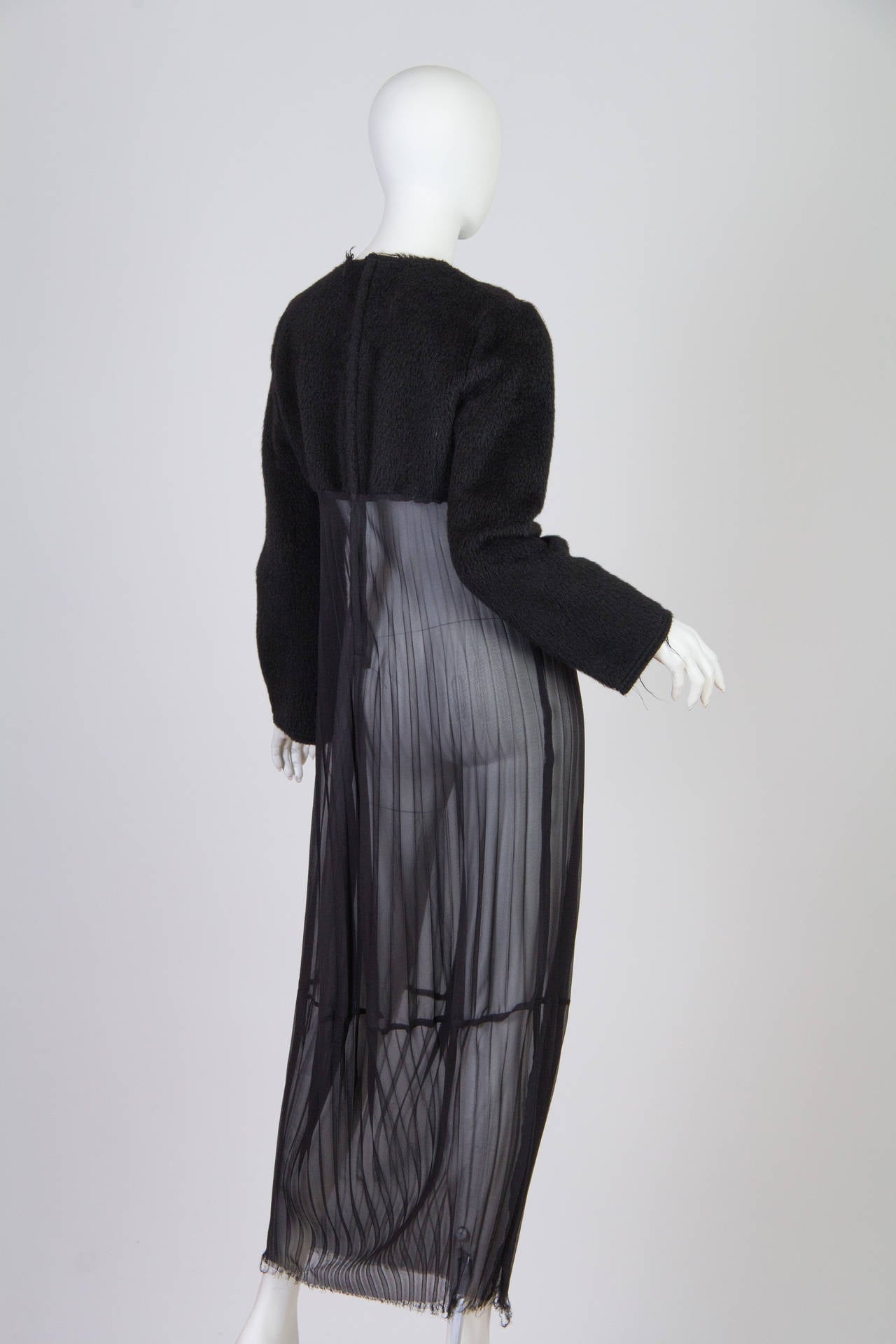This dress by avant garde design house Comme des Garcons sports a brushed felt-like sweater top and a sheer, pleated silk skirt. The boxy shape of the top and the long, straight sleeves keeps the dress from looking overly slinky or lingerie-like,