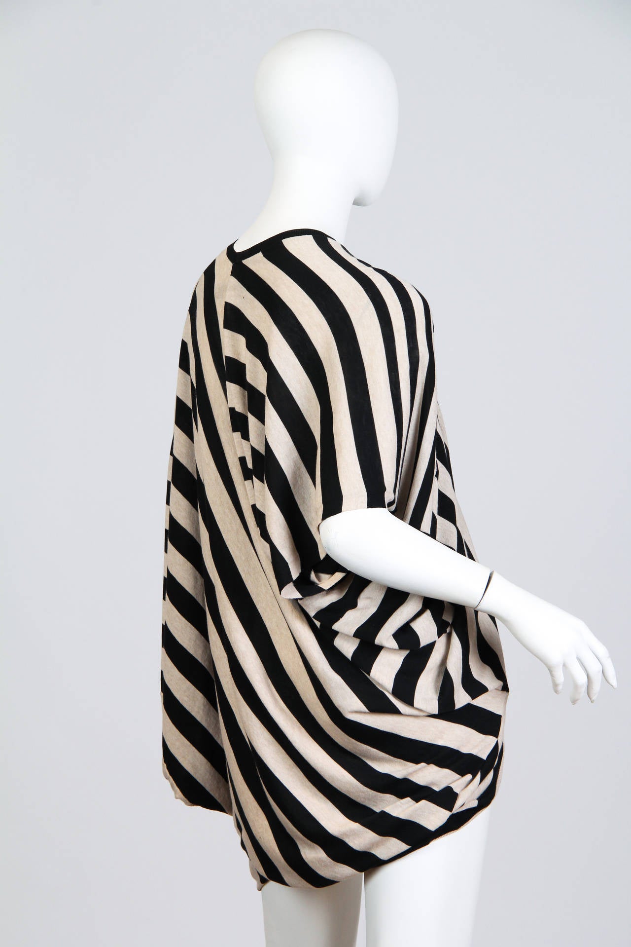 This is an elegant black and white striped top by Junya Watanabe for Comme des Garcons. It is elegantly drapey and oversized, yet the fine knit flatters the bust and hips. Changing diagonals in the stripes draw the eye across the form and add