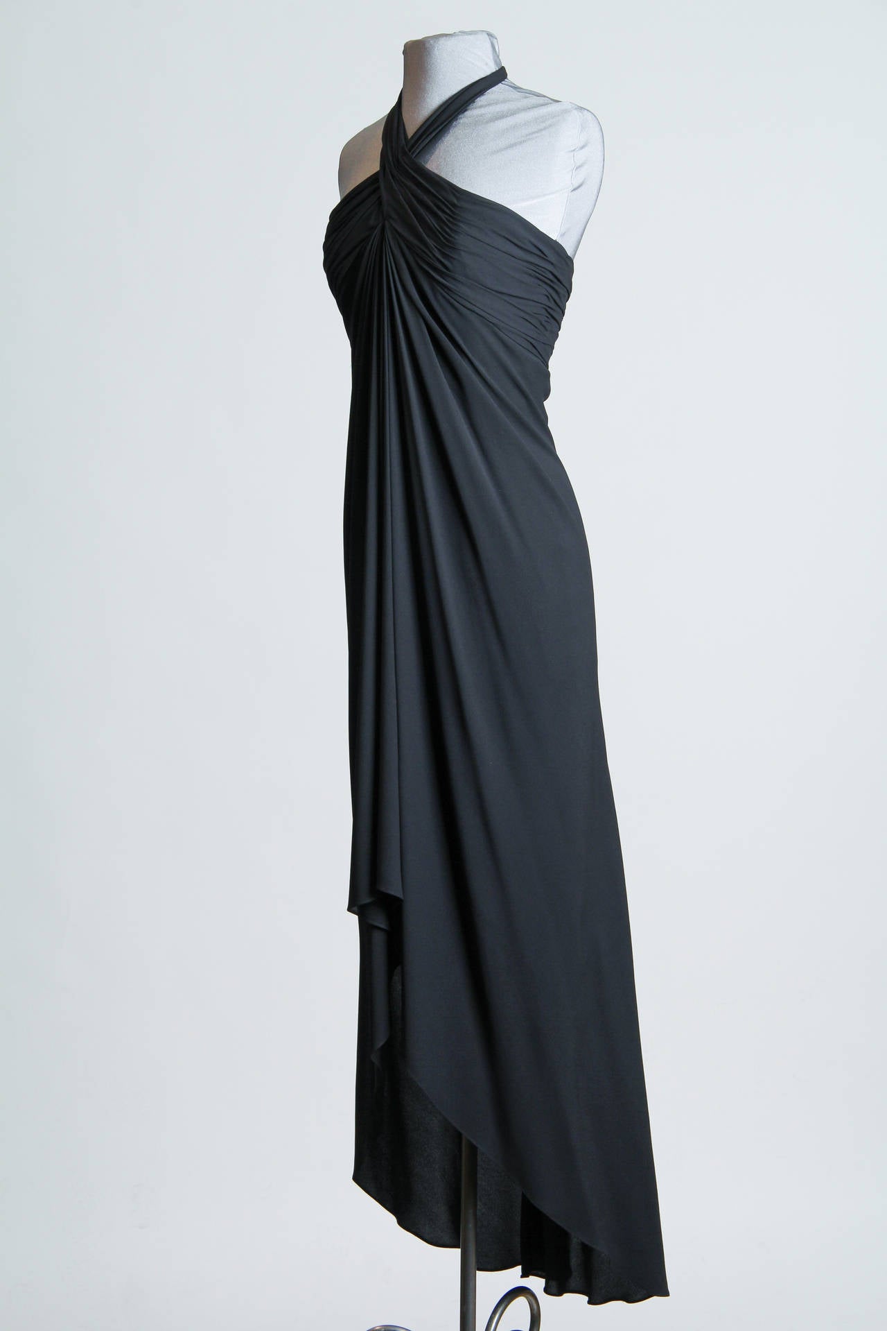 This flawlessly gorgeous gown dates to the days when Oscar himself was rubbing shoulders with Halston and Liza at studio 54. However the effortless design is anything but. The draped bodice has been hand stitched down to a fitted and boned bodice