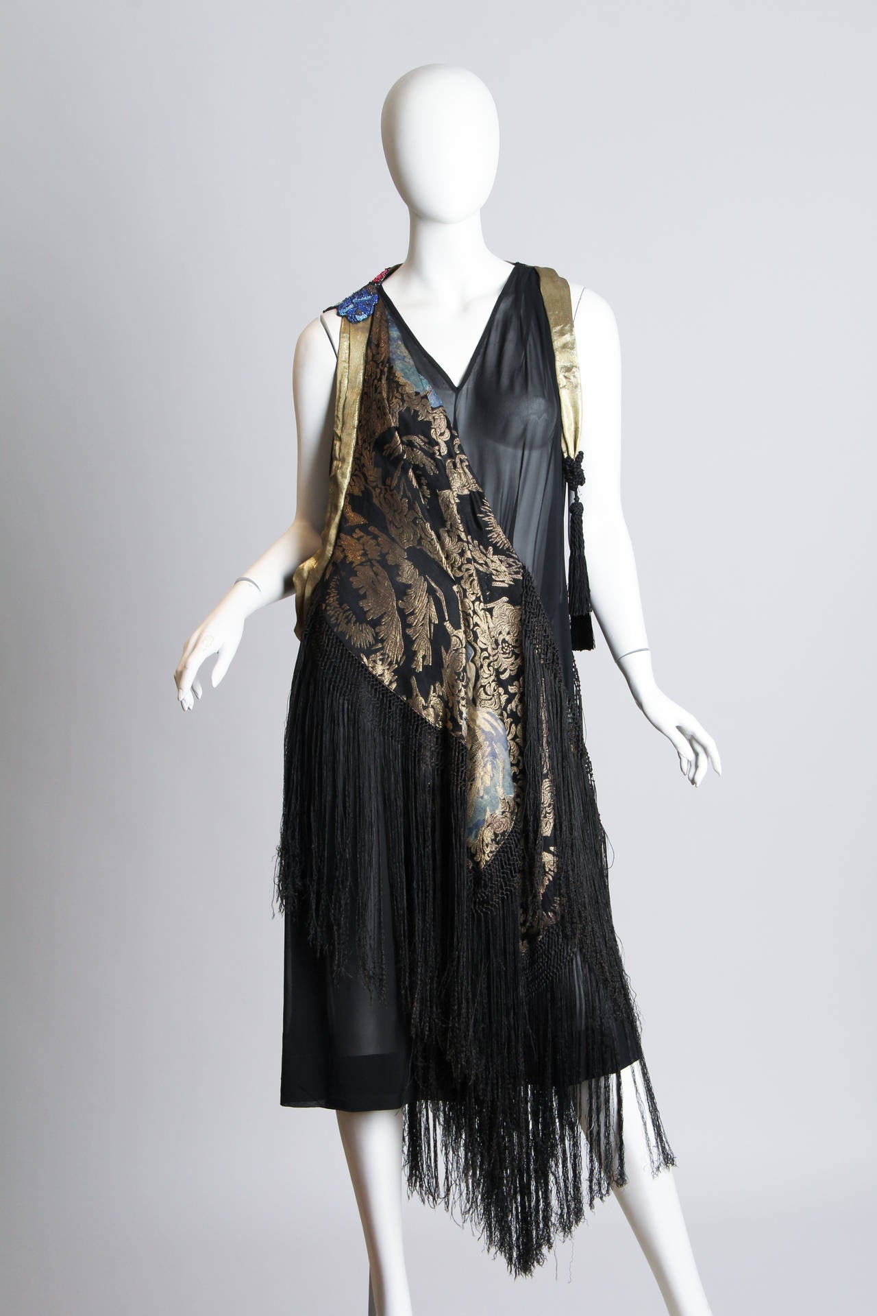 We do so much here with these antique shawls that we were happily pleased to see this original design from the 1920s. We've done some repairs and tightened up the seams and this dress is as ready to party as the day it was made. The dress is cut