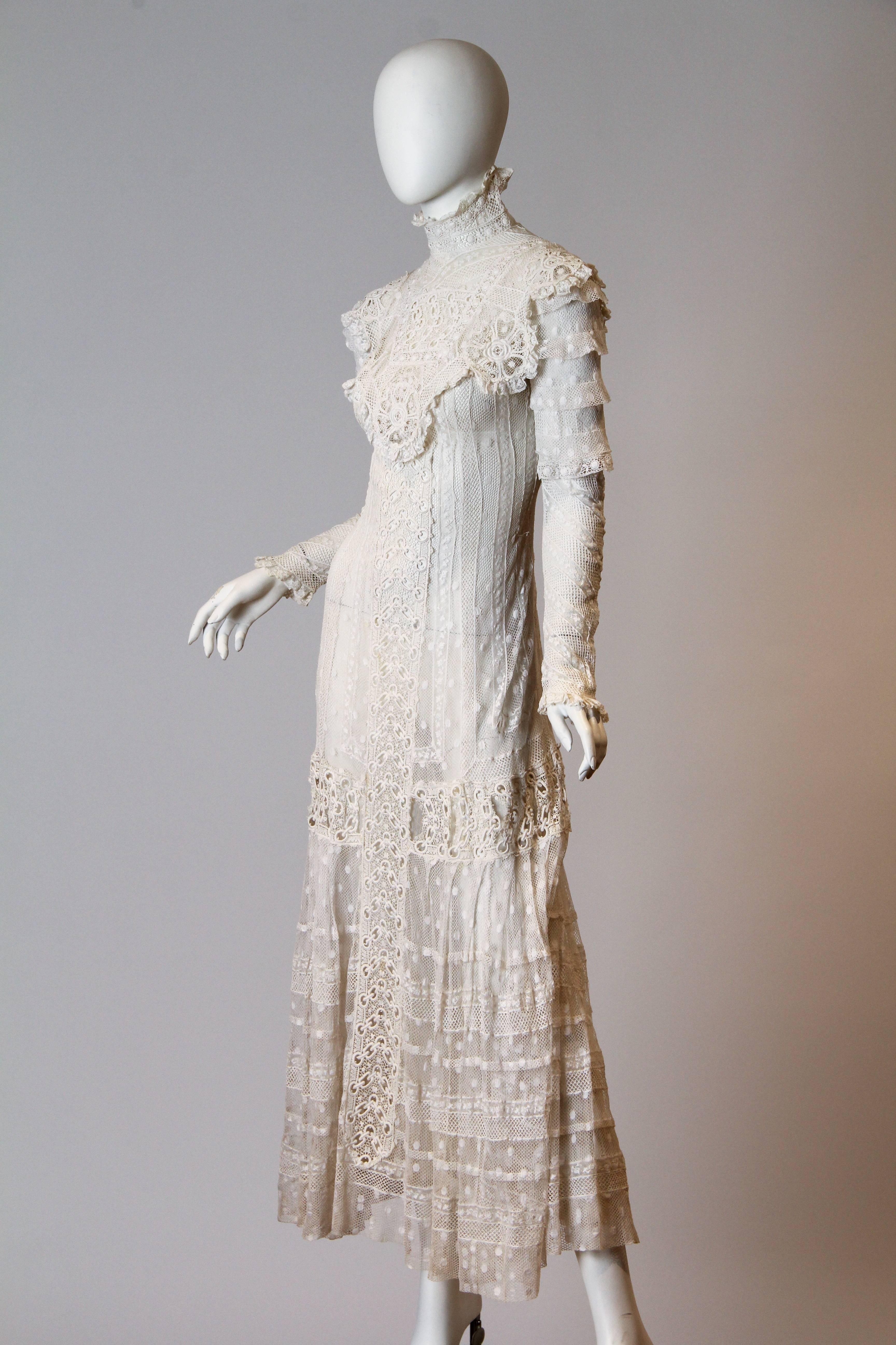 This is a breathtaking mesh and lace tea gown from the early 20th century, most likely made between 1908 and 1912. During this part of the Edwardian era, the extreme S-bend corset of the turn of the century was slowly morphing in shape and moving