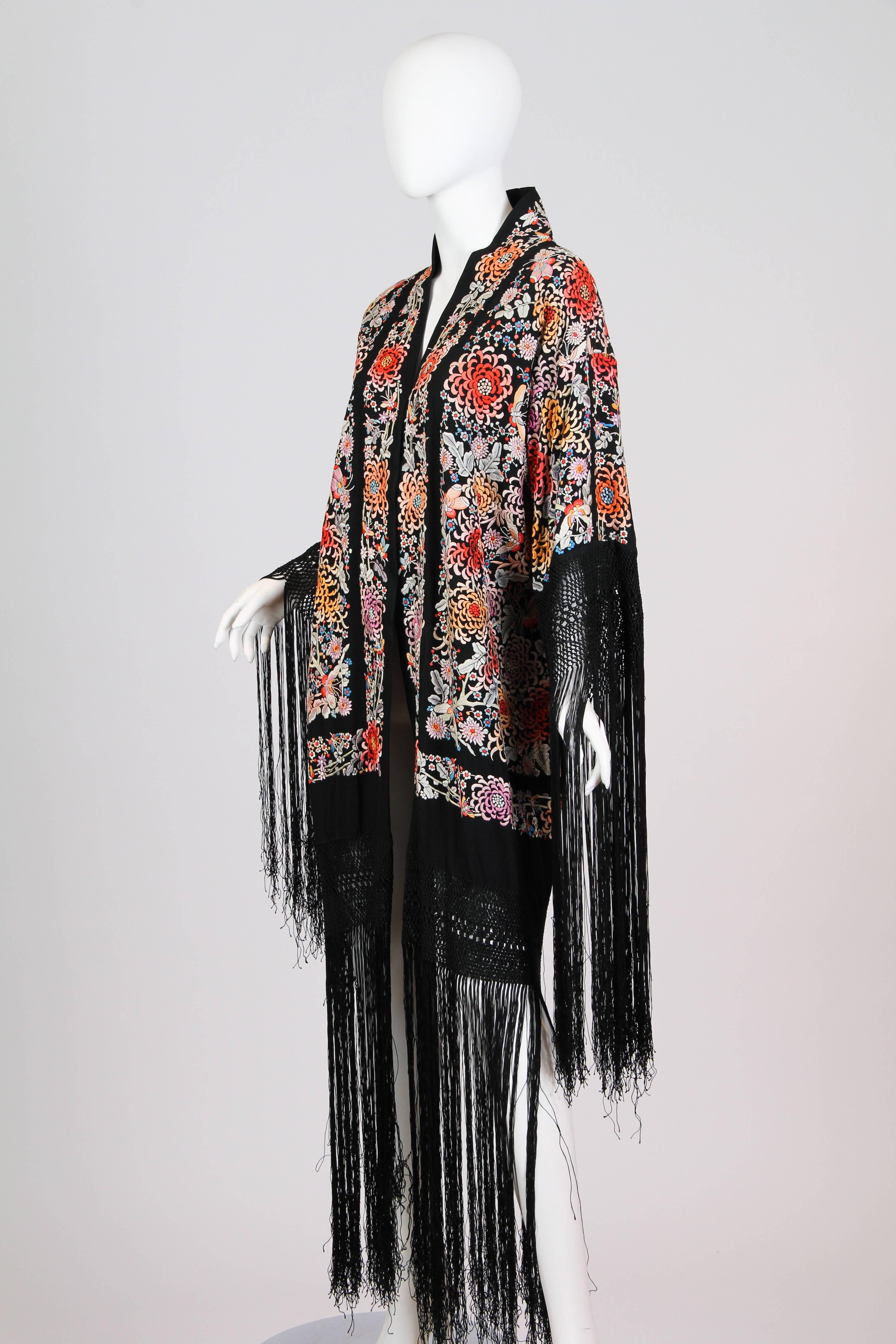 This is a piano shawl from the 1920s. These garments were originally meant just as their names suggest: as shawls for pianos. During the Orientalism craze of the 1910s, these sumptuous and heavily decorated textiles, which had been imported from