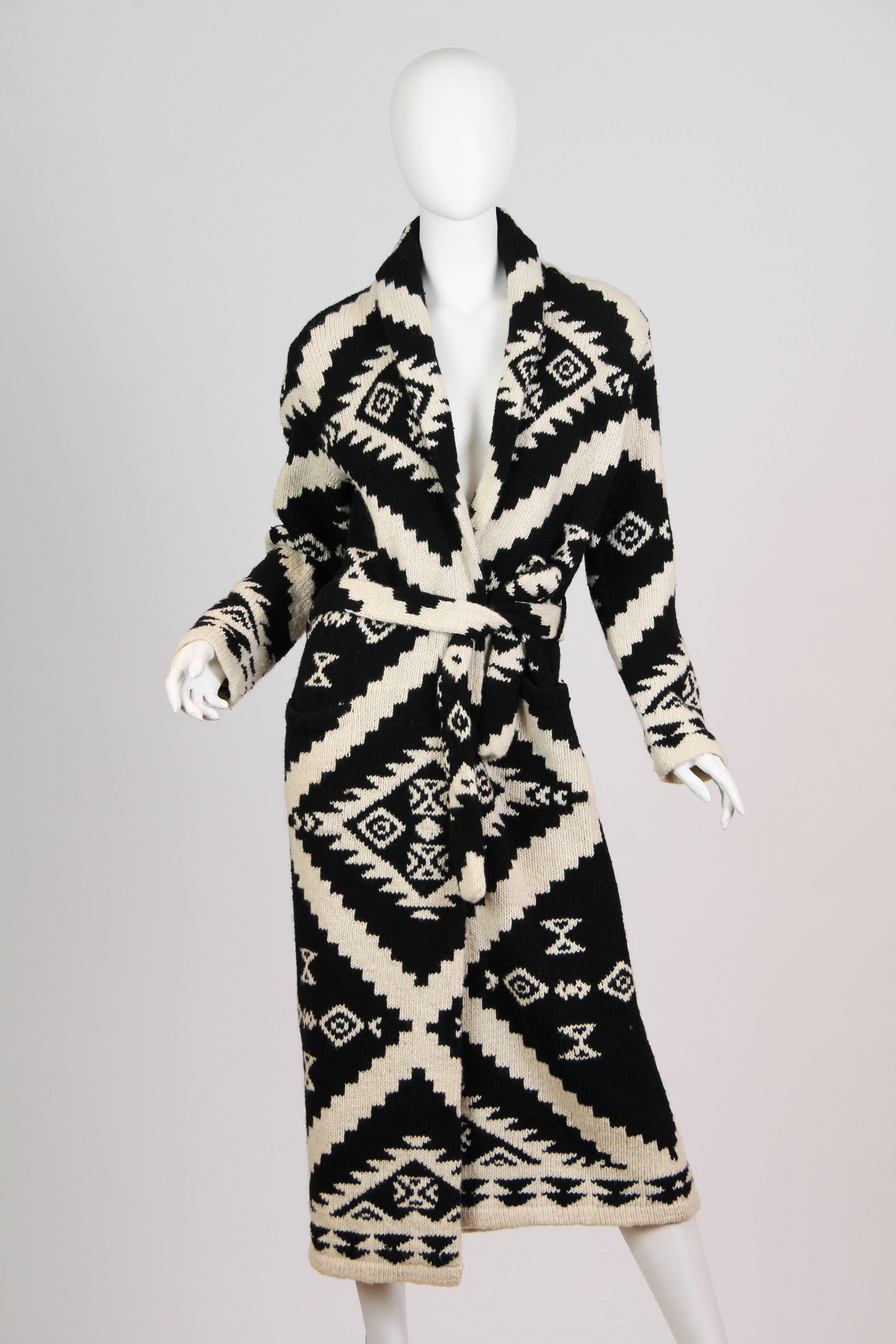 This is a beautiful cardigan sweater of black and white  knit. The thick knit is soft and cozy, and the deep black and creamy ivory shades are classically elegant - particularly in the shin-skimming length. The pattern is of geometric, zig-zagging