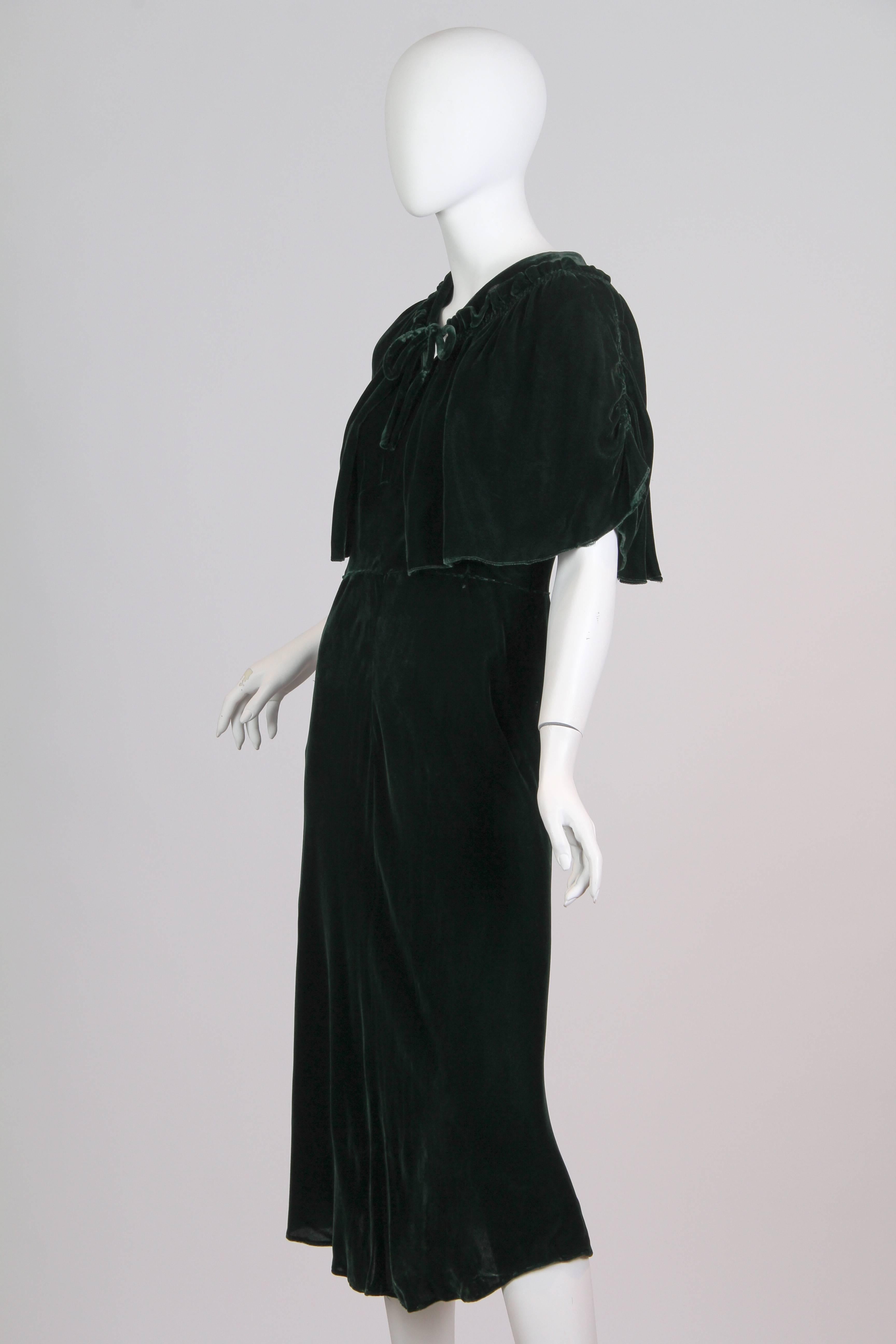 1930s Emerald Green Silk Velvet Dress cut on the bias with lovely cape like sleeves. Dress can also be worn front to back as it is cut trim and on the bias.