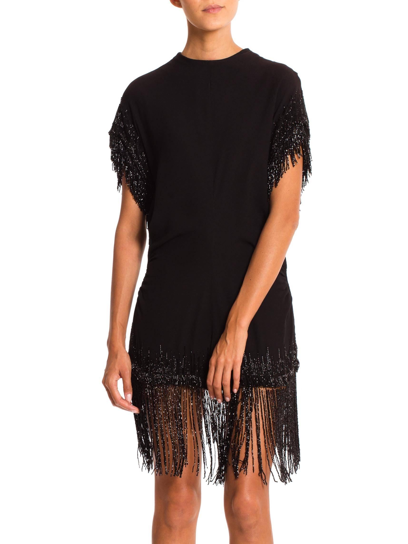 Gorgeous trails of beaded fringe come up the hem lines of this piece in an almost ombré tecnique. Meant to be worn over a full skirt in it's day it would work gorgeously over a pair of both slim as well as full trousers, try it with jeans even. Old
