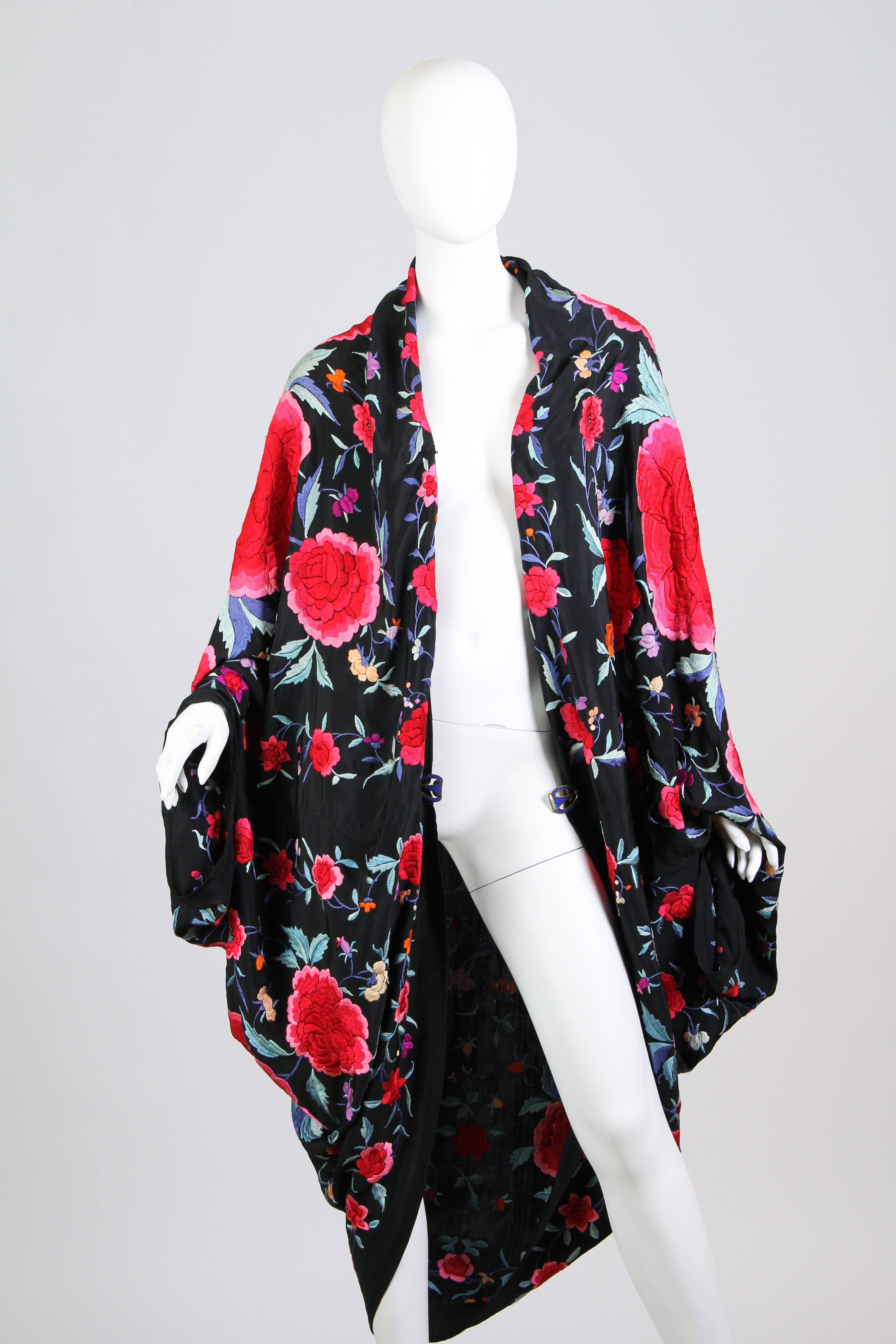 This is an absolutely incredible coccoon coat. The original shawl likely dates from the late 1910s or early 1920s. Made of a black silk ground with incredible polychrome silk embroidery worked by hand. The skillful craftsmanship and beauty of real