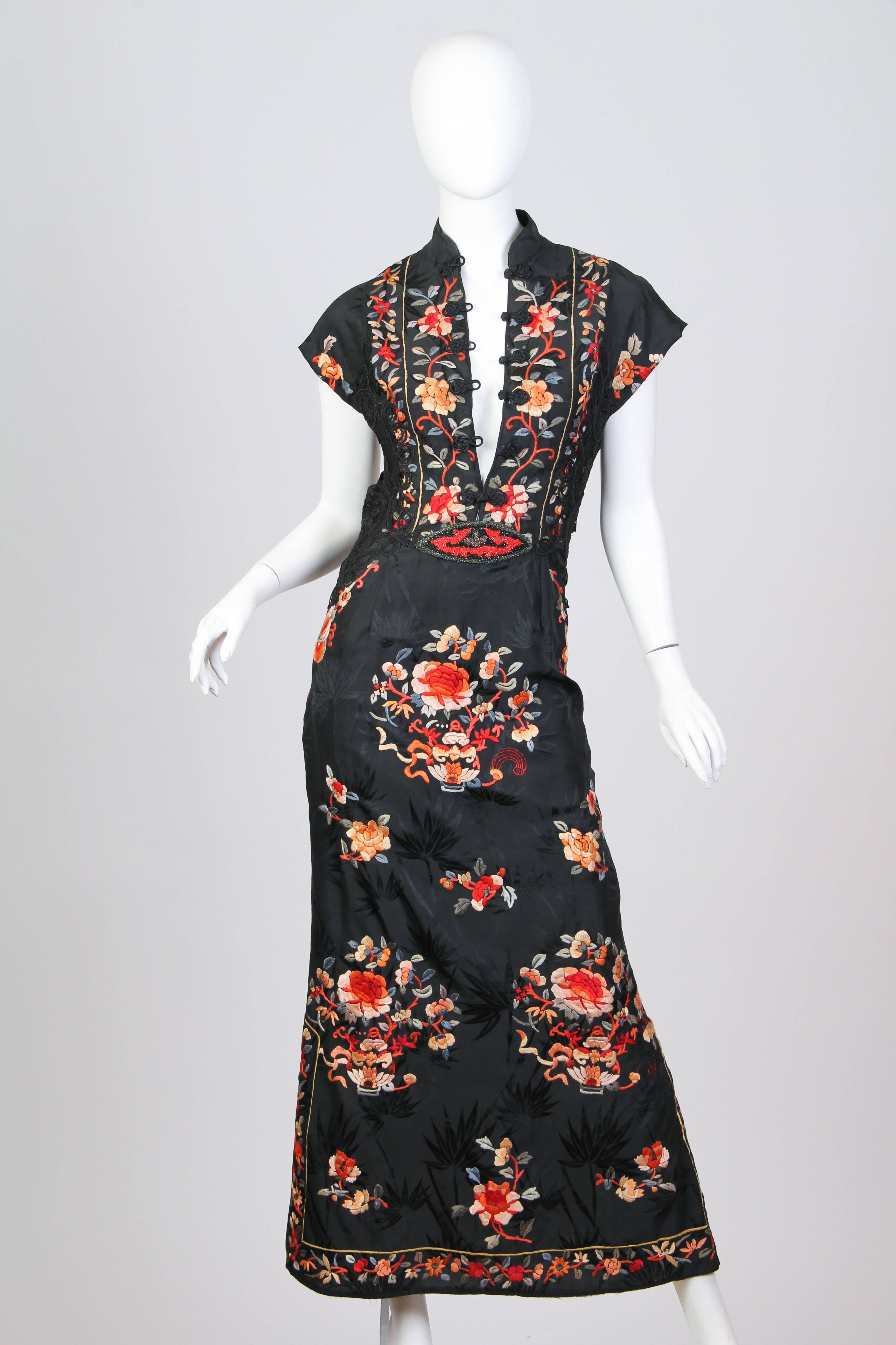 This is an updated Chinese Cheongsam or Quipao dress, inspired by traditional designs. Made from a set of antique 1930s silk pajamas with incredible floral hand embroidery. The dress is accented with 1920s beading, Victorian handmade lace, and
