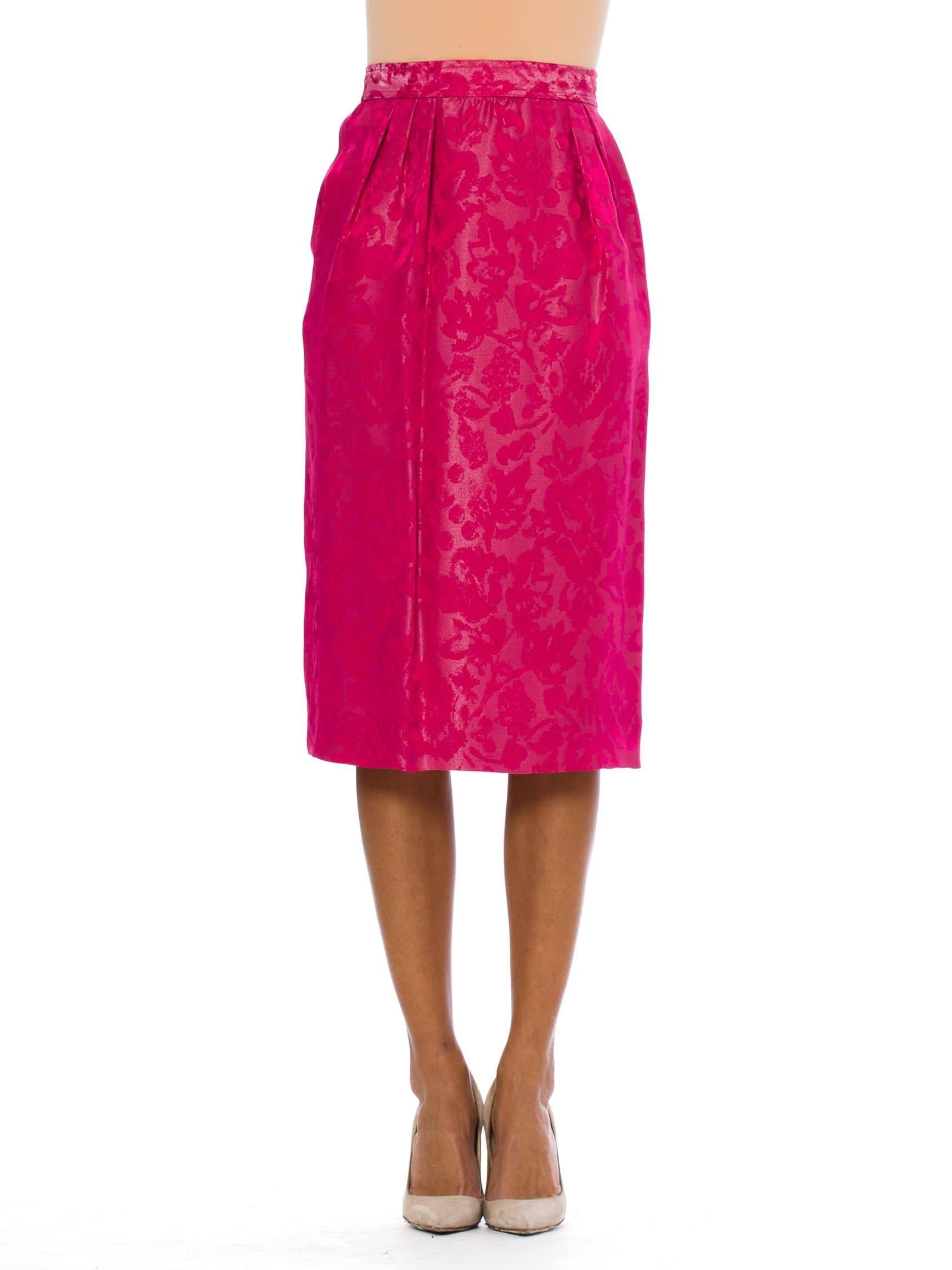 This is a gorgeous pink pencil skirt by French design house Lanvin. The fabric is an incredible fuschia-pink brocade, with subtle floral patterns woven against the shimmery background. The waistband is finished with a button at center back, and an