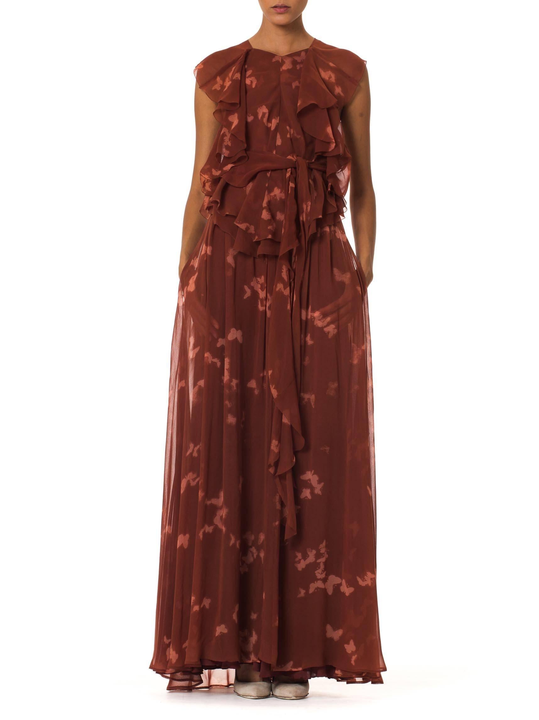 This is a gorgeous blouse and skirt set by Holly's Harp, printed all over with the white silhouettes of butterflies. Made of an earthy red chiffon, both garments are constructed of several layers of the fluttering sheer to allow light and air to