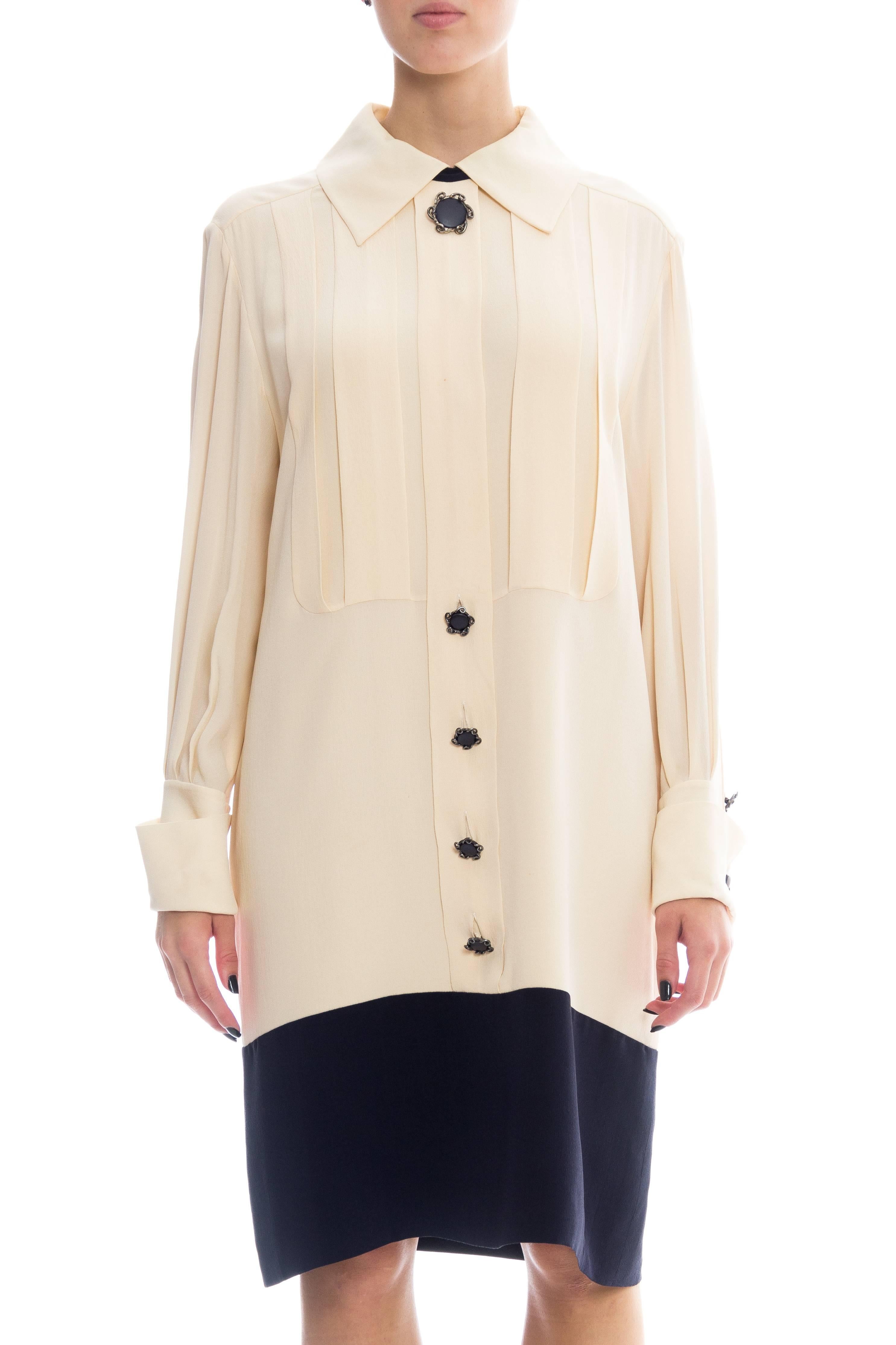 Karl Lagerfeld has beautifully interpreted a 19th century men's shirt into a lovely dress which can be just as formal as it is informal. In classic Karl cream and black this dress is flattering to every skin tone. The wonderful custom buttons which