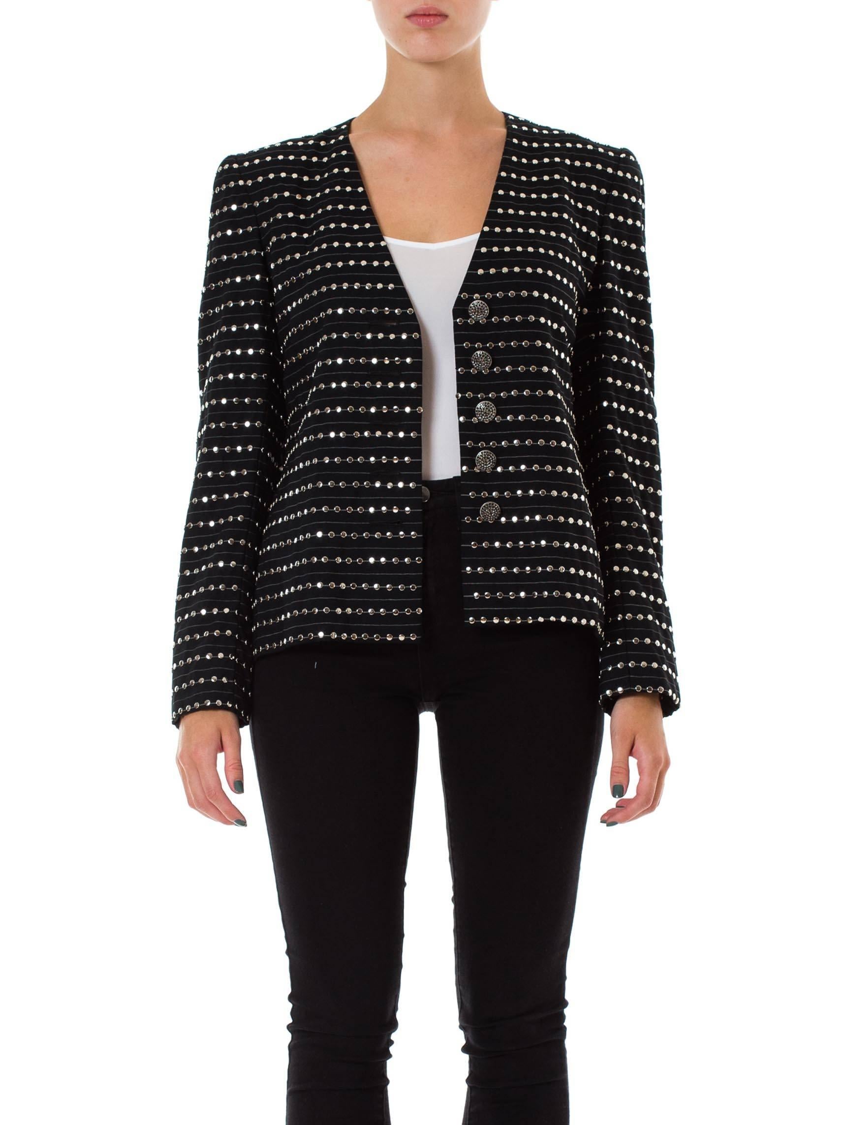 Rock and roll goes to the boardroom must have been what James Galanos  was thinking when he designed this jacket. Traditional suiting pinstripe wool has been used horizontally with rows and rows of hand applied metal studs. This isn't the cheap St