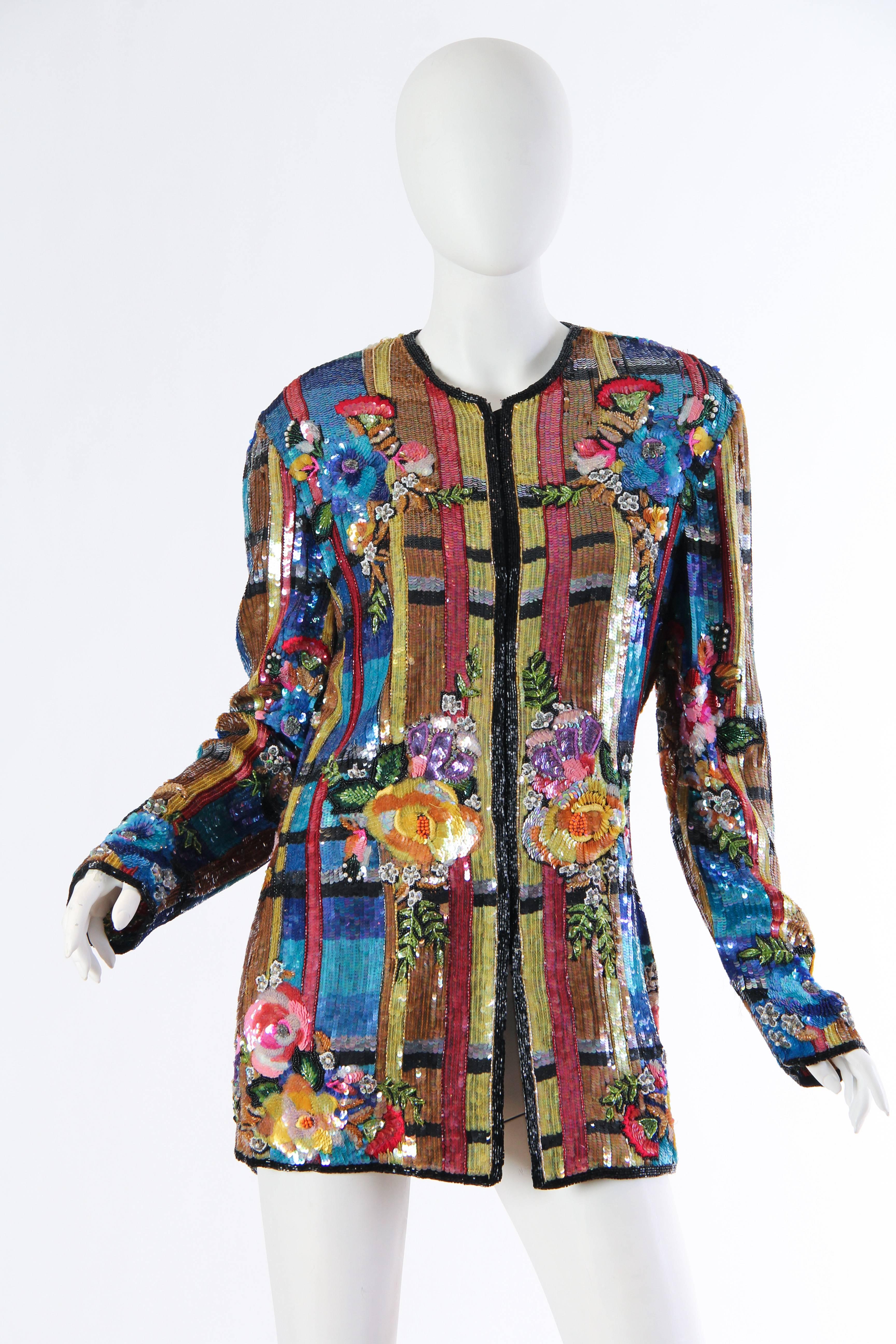 1980s sequins and beads from Naeem Khan. Why wear Balmain when you can wear Khan? Shimmering flat sequins create a color blocked ground upon the body in which artesian flowers of beads and embroidery bloom. This loosely cut jacket is easy to wear