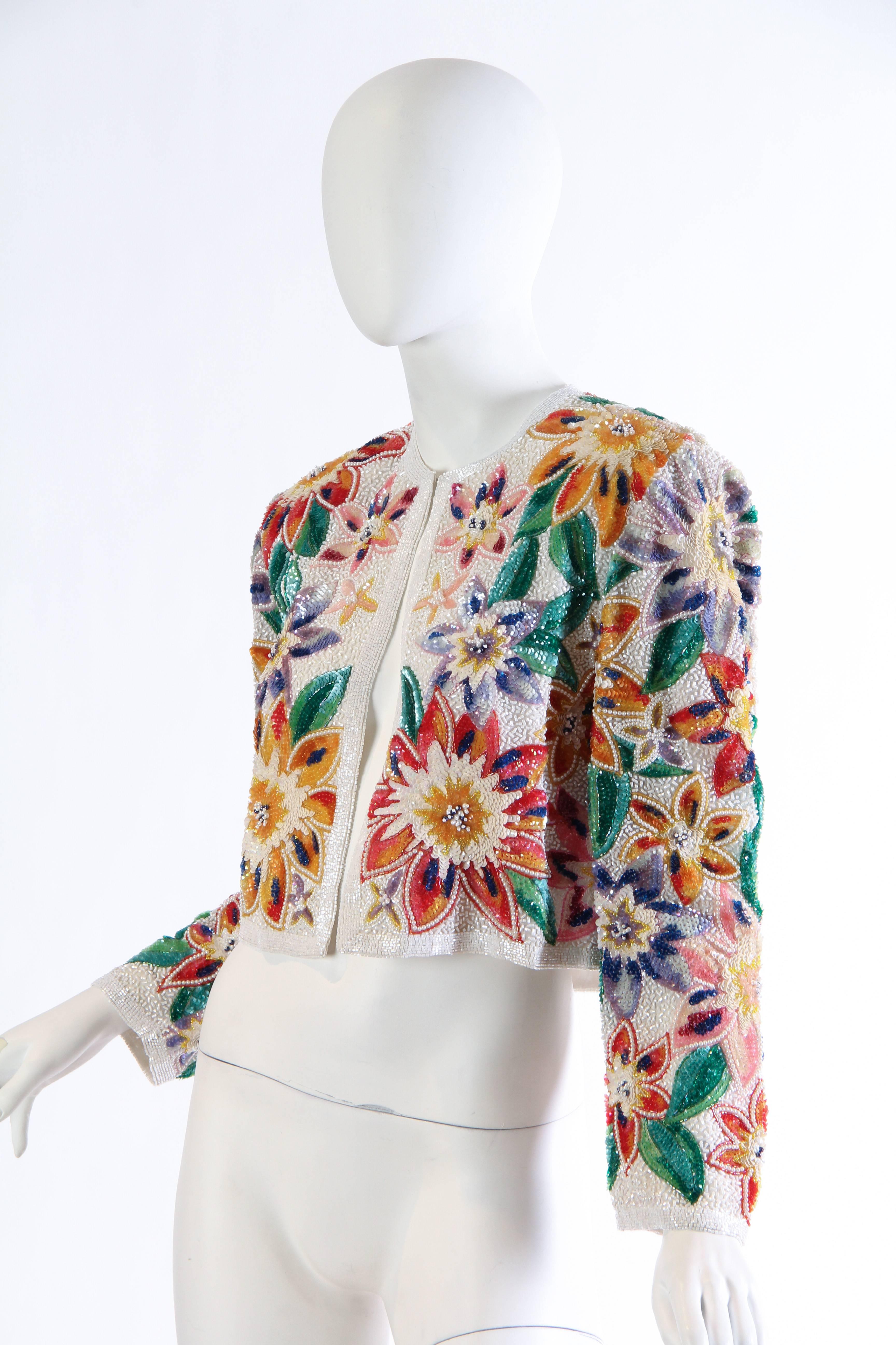 Fantastic tropical flowers bloom right out of the fabric of this luxe evening jacket from Naeem Khan. An array of shades of colors and beads creates this illusion and it is magical. The perfect little cover up for a beach bride or for a night out in
