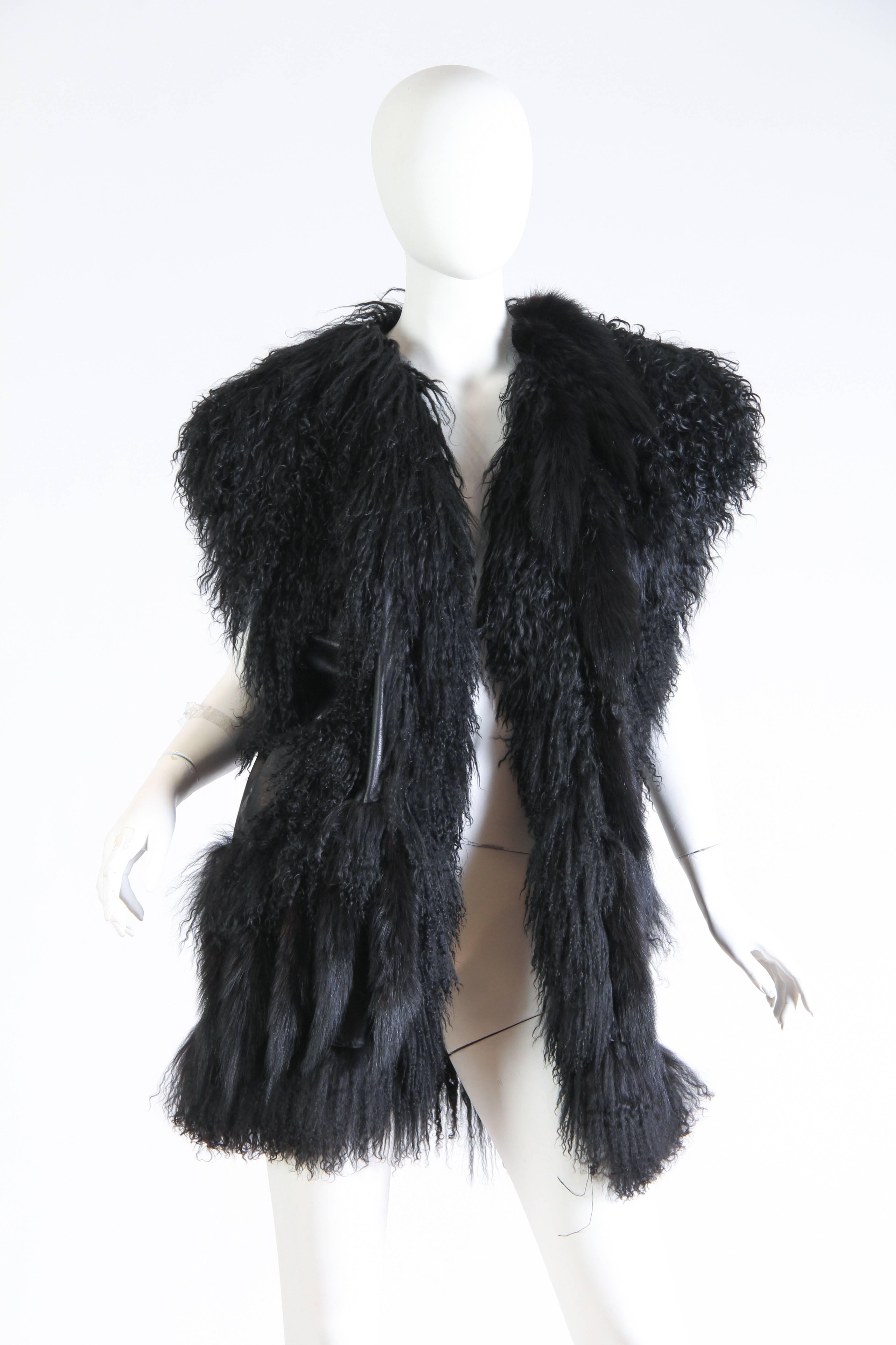 Asymmetrical pieces of mongolian lamb and leather have been artfully pieced together creating a luxurious patchwork. The leather and fur are in top buttery soft condition and this piece appears to have not been worn. 