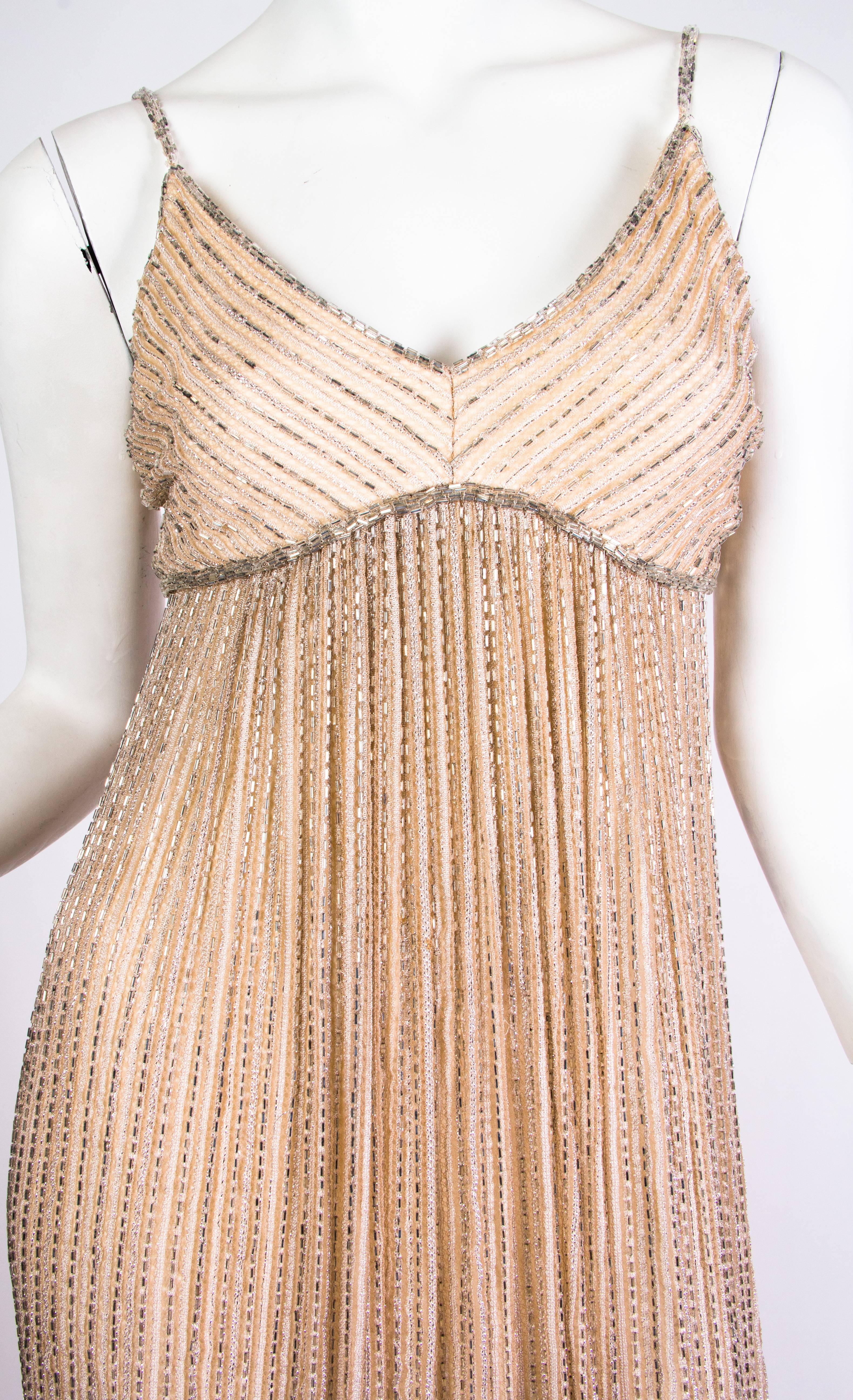 Dress comes with a matching beaded lace capelet which can be worn several ways. 