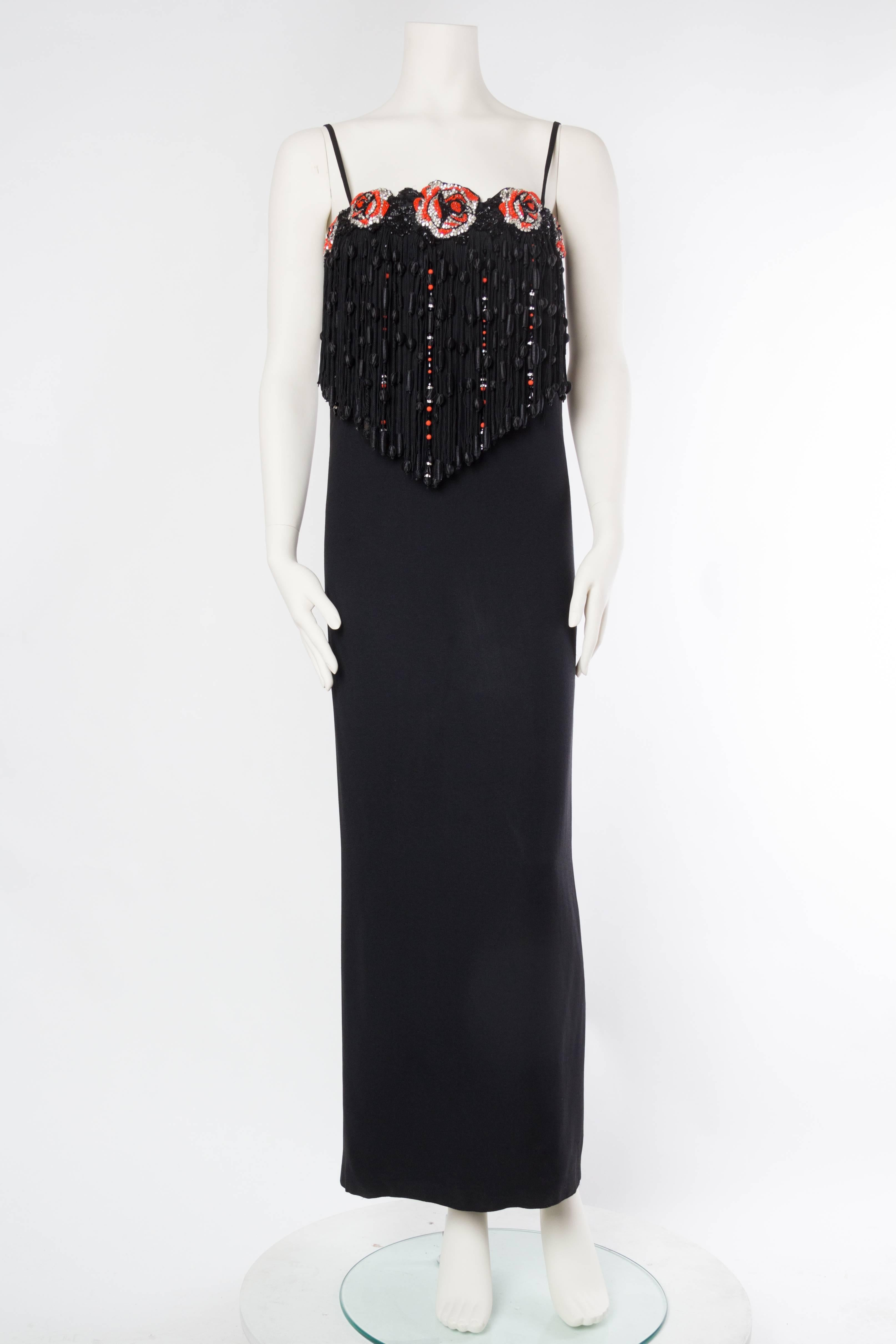 Demi Couture construction with a fitted internal bustier & hand set zipper. Fully lined in self fabric.  1970S VALENTINO Black Silk Crepe Gown With Beaded Crystal Roses & Epic Passementrie Fringe 