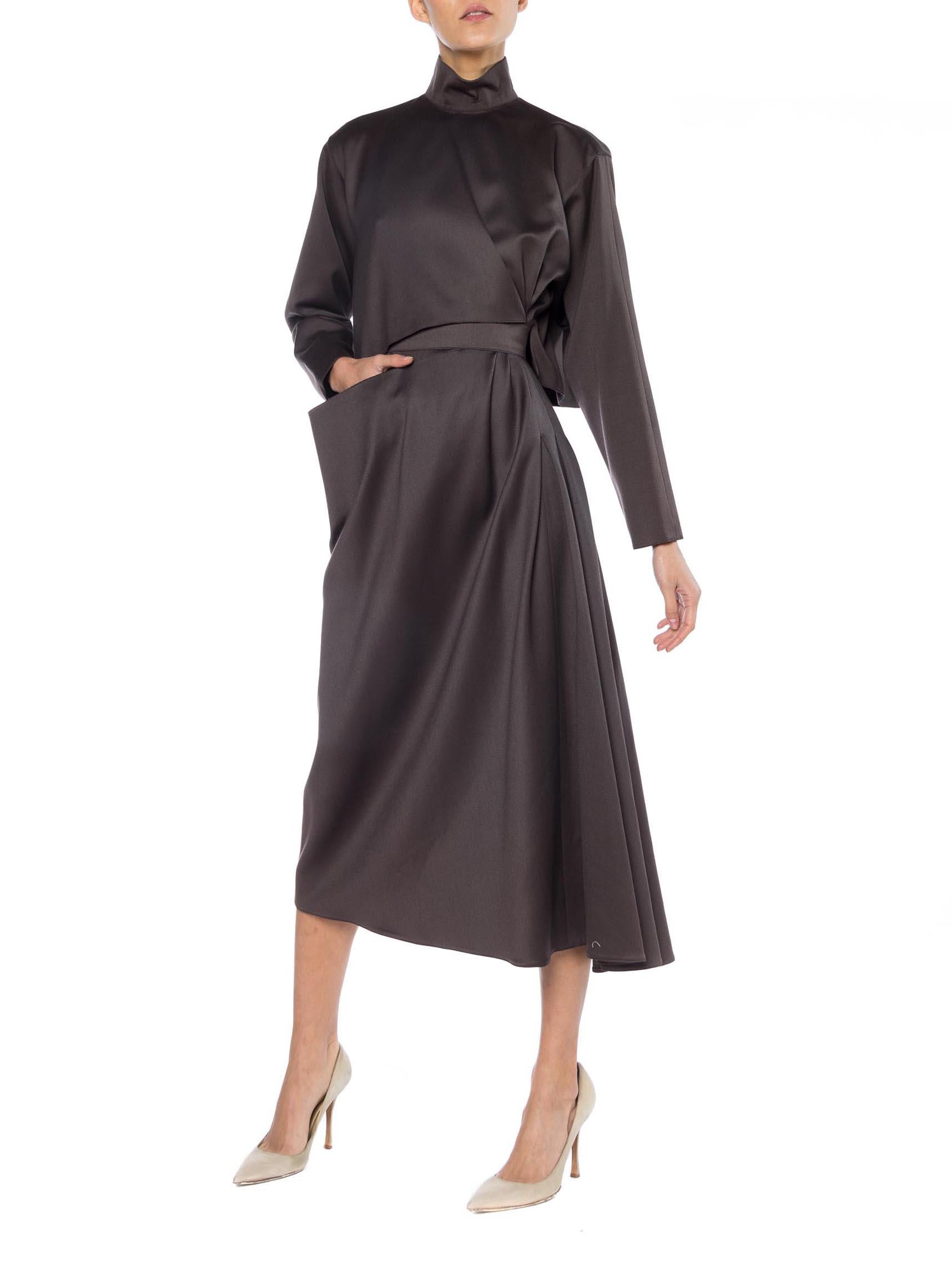 Modern and yet timeless, gorgeous silken wool dress which looks to have been inspired off of a trench coat. 