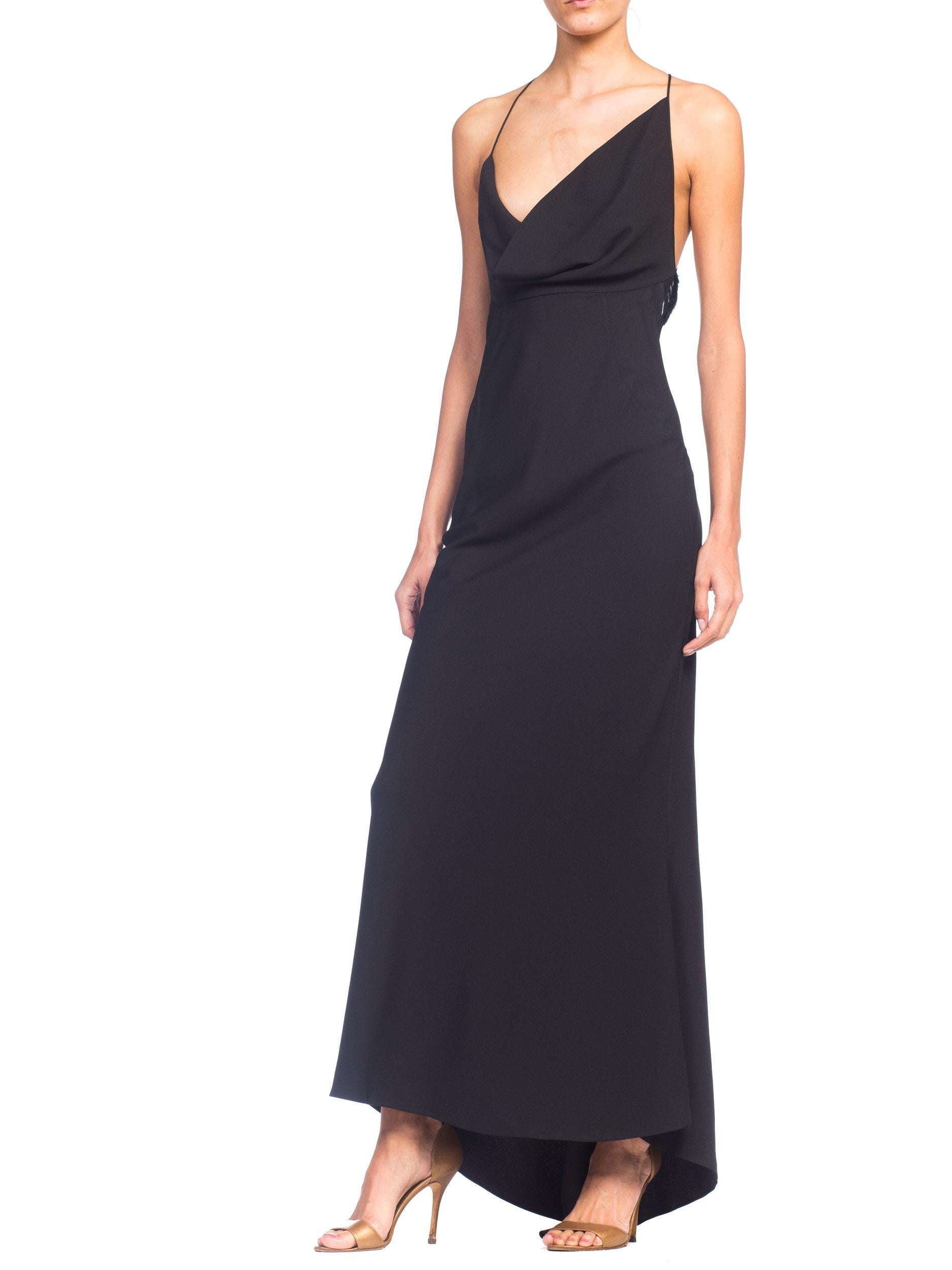 This gown is shot on a 5'11'' model so on a shorter woman it will train a little. Modern late 90s asymmetrical Galliano style draping to the front, with a sheer panel around the lower back trimmed in a very Cavalli way with fur. 