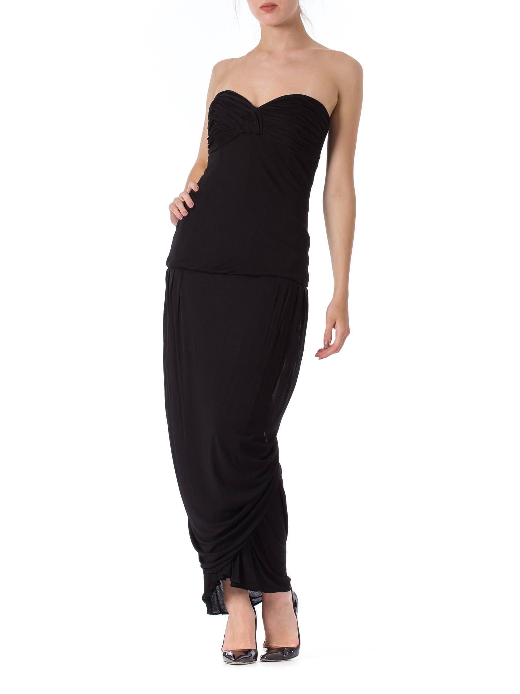 Classic, cool and sexy. Silk jersey drapes and wraps around the body creating interesting lines as the wearer moves about. The elegant strapless design stays in place as it is built on a fitted and boned bodice. Silk jersey is in great condition.