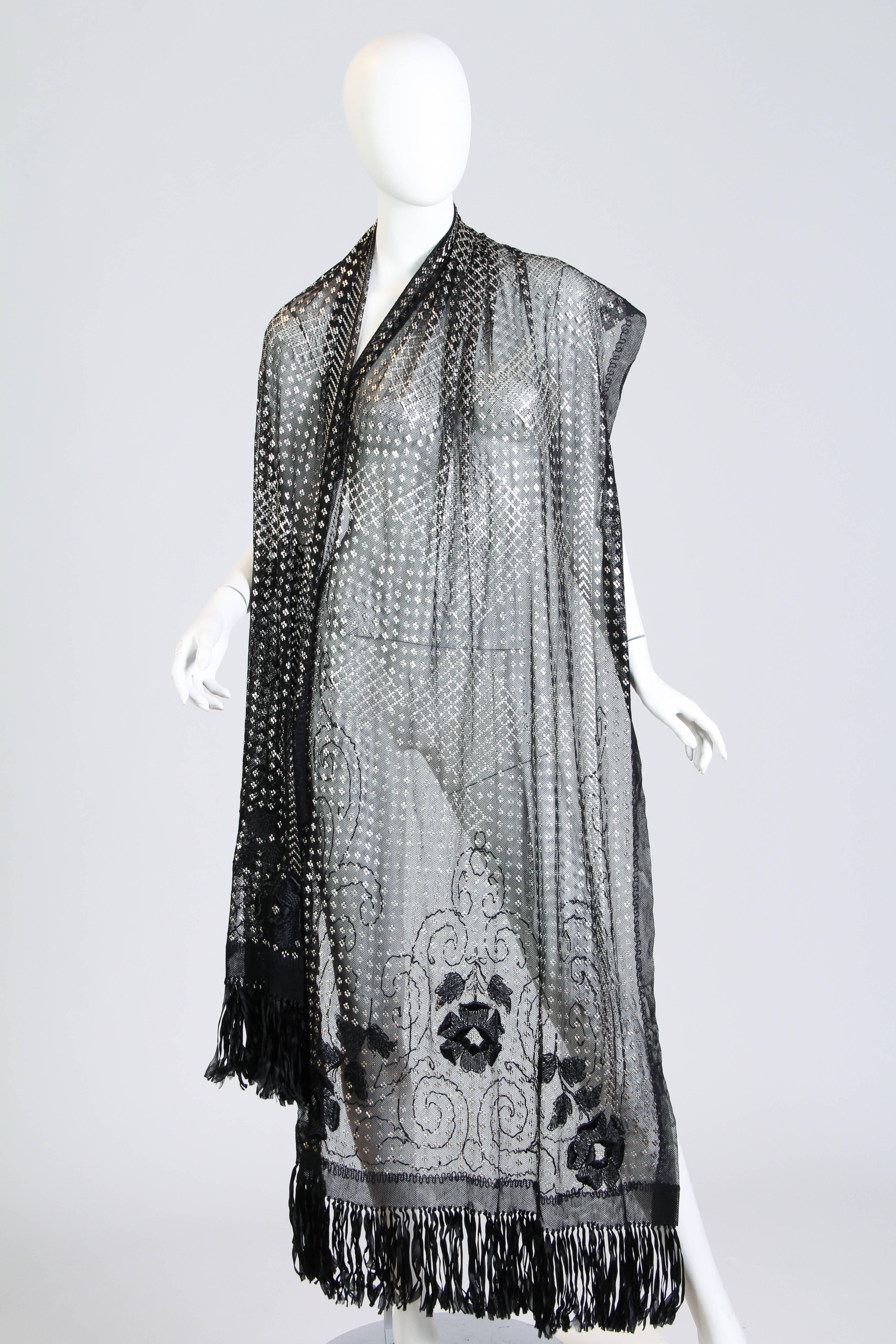 Never before have we seen an asuite shawl with silk Edwardian embroidery and fringe. This marks this piece as a very rare and luxurious find. The shawl is in near mint condition and is also very long for these. Made with silver in the net as dowery