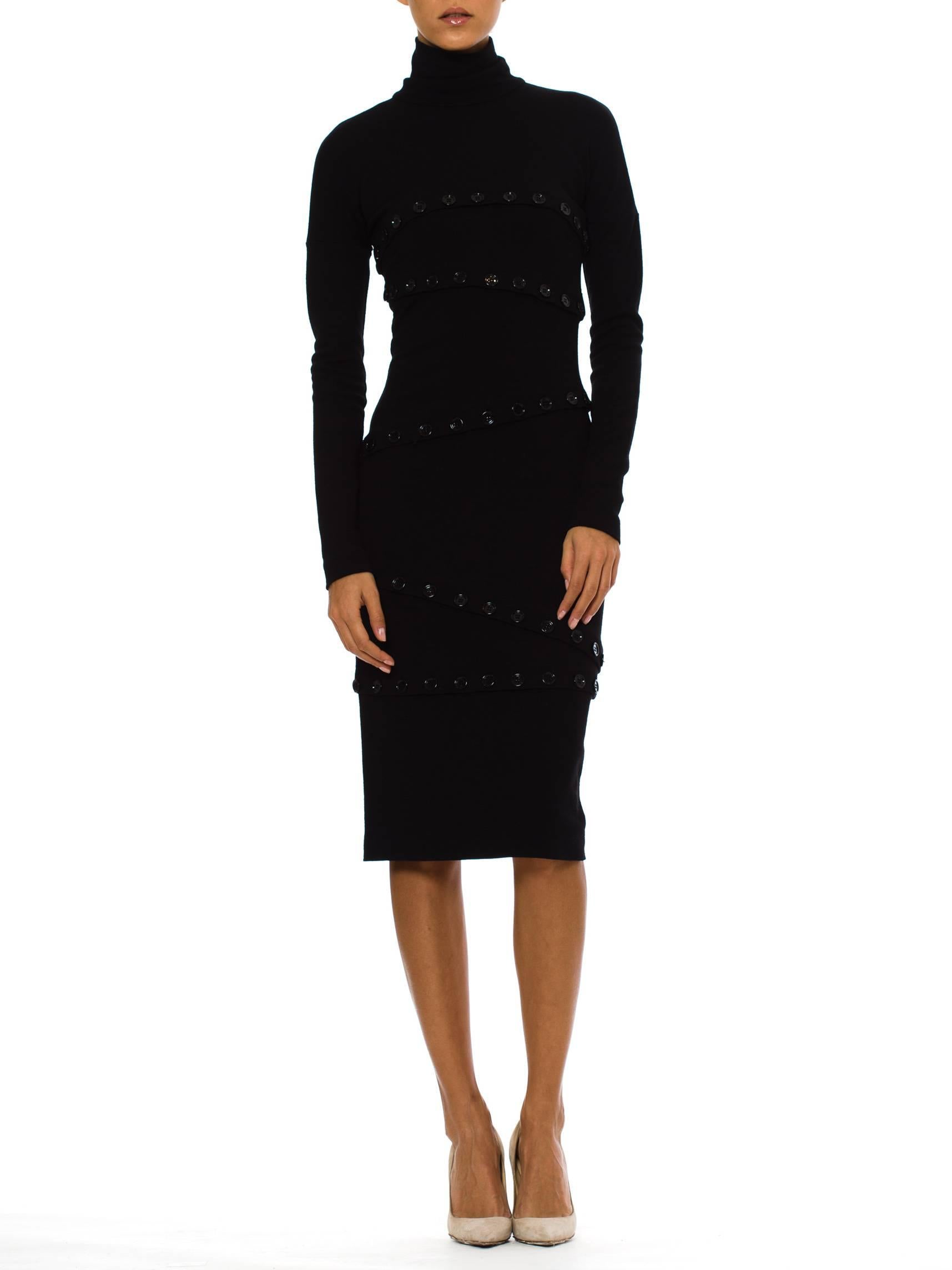 This is a striking turtle-necked dress from Dolce and Gabbana. The base of the dress is a simple and flattering affair: a body-conscious silhouette in a fine knit, with long sleeves, a single-layer turtleneck, and a knee-length hem. The