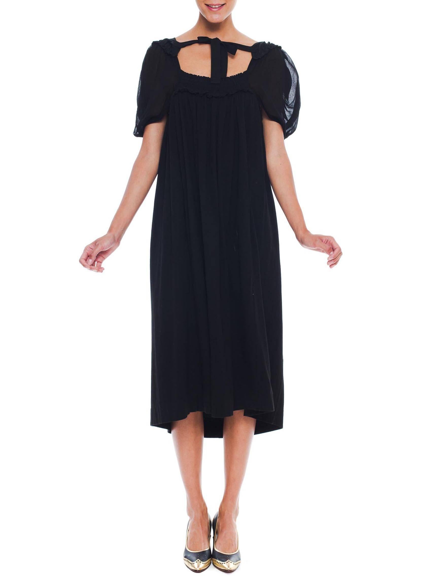 Cotton jersey and rayon crepe chiffon have been draped, pleated, and pulled together into an artful arrangement in this dress from Comme des Garcons. Cut with a free size the dress is comfortably flattering and easy to wear. The cut out back adds