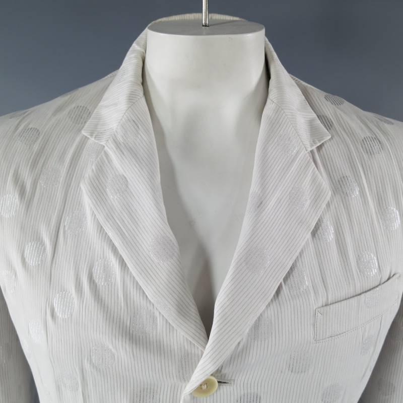 This rare vintage YOHJI YAMAMOTO sport coat comes in a white cotton with micro pinstripe and metallic silver stripe polka dots and features a wide notch lapel, three button closure with beige buttons, breast pocket, flap pockets, and a ventless