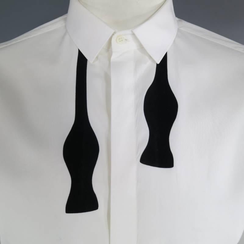 Neil Barrett Long Sleeve Shirt consists 100% cotton material in a white color tone. Designed with a black velvet print bow-tie, pointed slim collar, hidden button front and tone-on-tone stitching along shoulders and seam. Detailed with a single