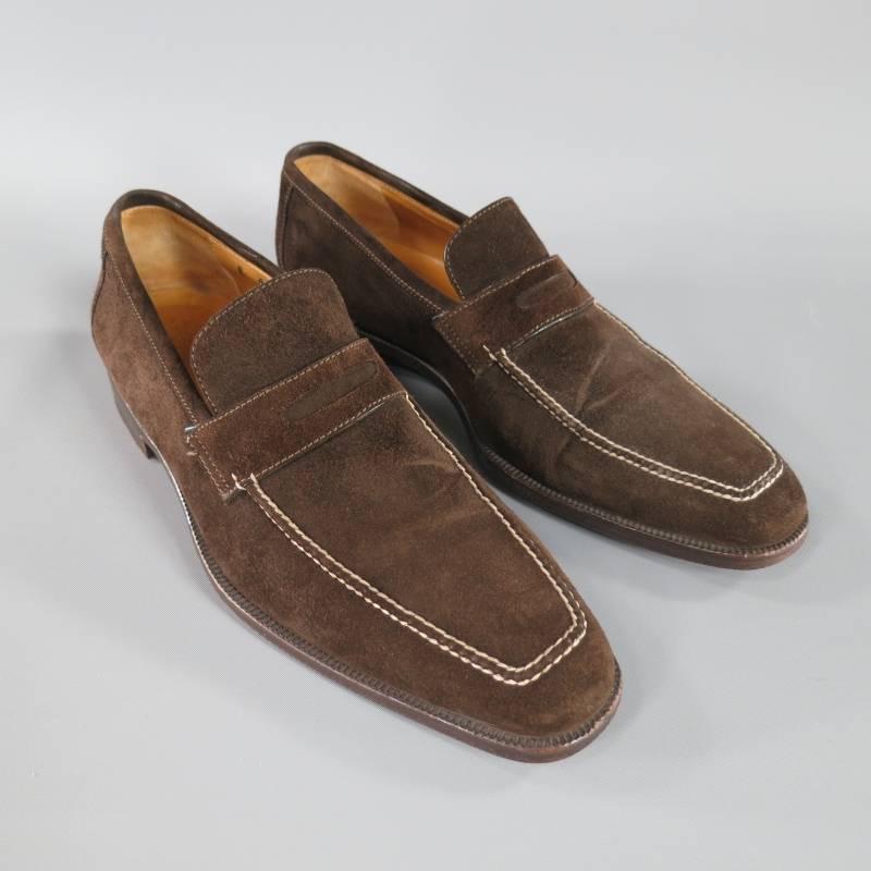 Sutor Mantellassi Loafers consists of suede material in a brown color tone. Designed with a square toe front, white contrast stitching along top surface and tone-on-tone stitching. Vamp section features penny loafer detail with open cutout. Brown