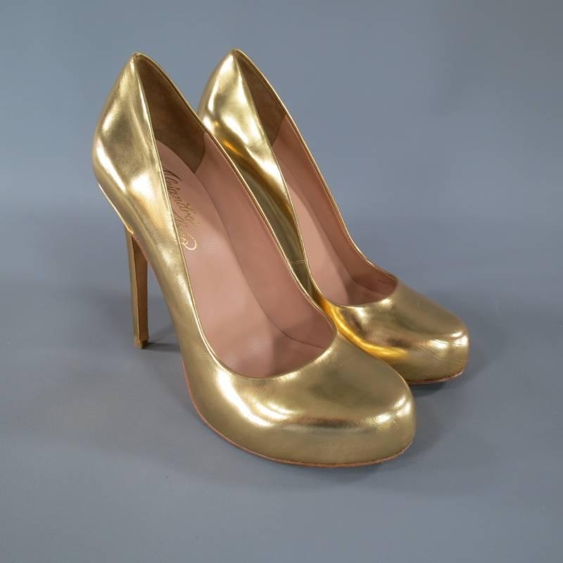 These fabulous platform pumps by ALEJANDRO INGELMO come in a glossy metallic gold leather and feature a rounded toe, hidden platform, and high stiletto heel. Made in Italy.
 
Excellent Pre-Owned Condition.
 
Platform: 1 in.
Heel: 5 in.