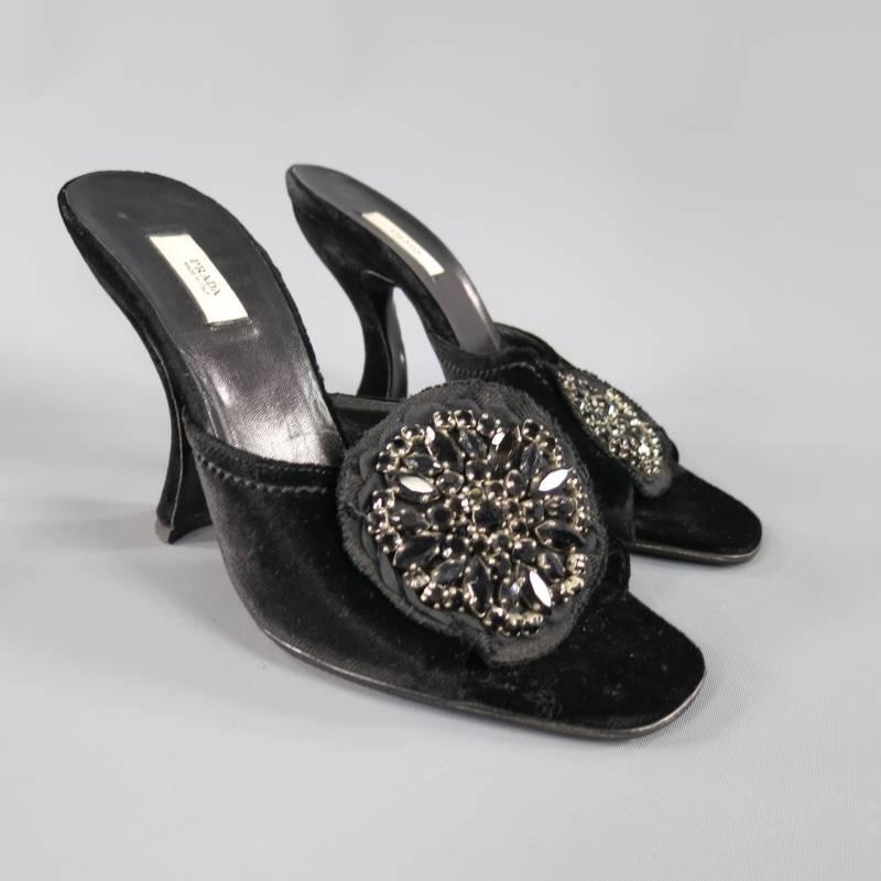 These fabulous and rare PRADA mules come in a lush black velvet and feature a thick peep toe strap with a beautiful large black sparkling crystal embellished fabric flower applique and a structural curved heel. These come in excellent condition,