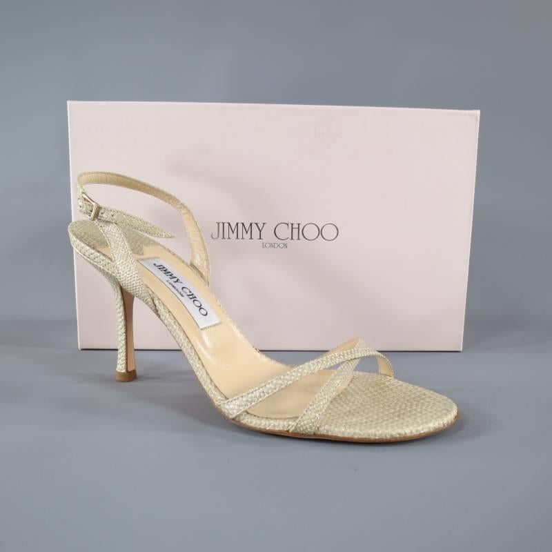 These gorgeous strappy "Karung" sandals by JIMMY CHOO come in a sparkly gold beige snake gator embossed material and feature a skinny X toe strap, sling back with buckle closure, and stiletto heel. with Box. Made in Italy.
 
Pre-Owned
