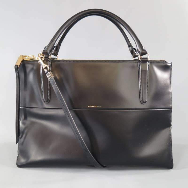 This COACH Borough Bag comes in a smooth black leather and features a two paneled front with gold foil logo, triple gold tone ziz closure with three compartments, top handles, and a detachable shoulder strap.
 
Excellent Pre-Owned Condition.
