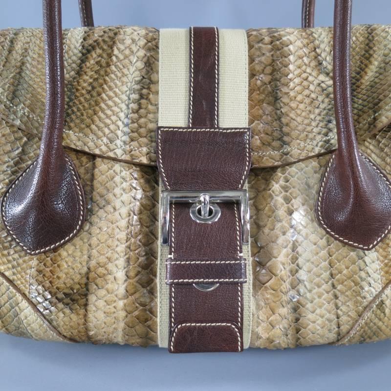 This rare shoulder bag by PRADA comes in a gorgeous tan python skin leather and features a flap with a tan and brown canvas belt with buckle snap closure, brown leather straps with contrast stitching, drawstring sides with grommets, and internal