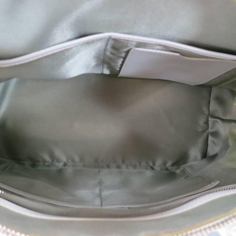 This fabulous handbag by GIORGIO ARMANI comes in a white crocheted leather and features corner panels, double belt buckle top handles with silver tone hardware, zip lock closure, detachable shoulder strap, and internal storage pockets. Made in