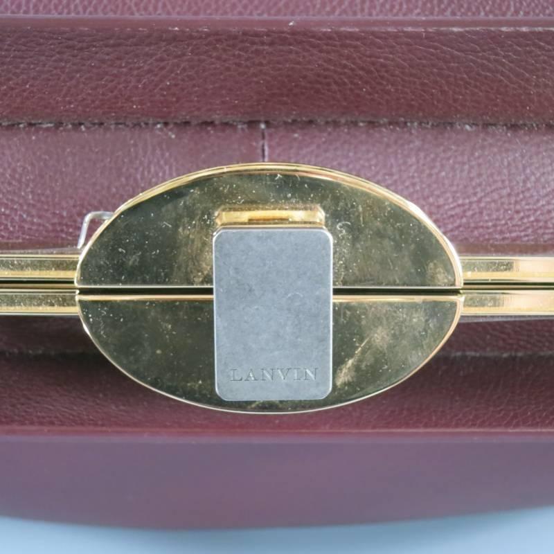 This ultra rare LANVIN doctor bag comes in a rich oxblood burgundy smooth leather and features a gold tone frame (that still has the protective seal on it), snap lock top closure, double top handles with gold tone screw hardware, and internal