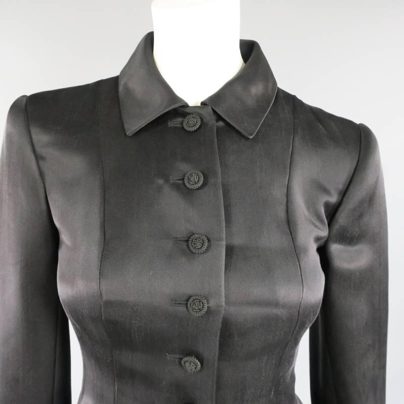 This ultra chic vintage OSCAR DE LA RENTA jacket comes in a plush black silk and features a pointed collar with snap, button up front with braided buttons, and a cropped box pleated peplum at the waist. Made in USA.
 
Excellent Pre-Owned
