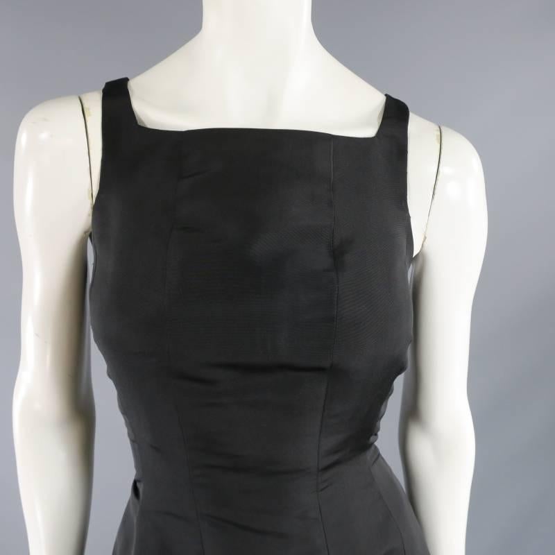 This gorgeous vintage OSCAR DE LA RENTA cocktail dress comes in a structured black silk and features a square neckline with slim straps,  fitted body, and drop waist with layered ruffle skirt. A classic style with timeless appeal. Made in The USA.
