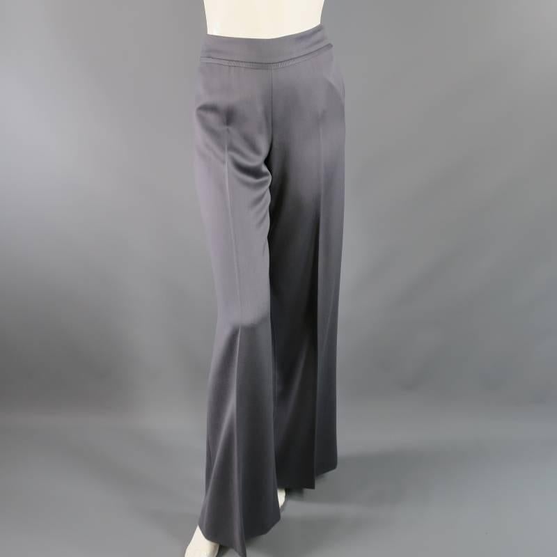 These ultra chic OSCAR DE LA RENTA high rise dress pants comes in a soft silver grey wool and feature a a thick waist band with raw edge ribbon, single pleats, and a wide leg. Made in Italy.
 
Excellent Pre-Owned Condition.	
Marked: 2
