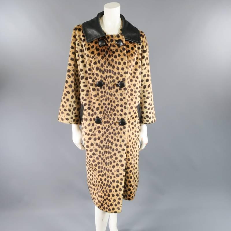 This fabulous vintage CHITA by FAIRMOOR coat comes in a tan spotted cheetah print faux fur and features a bell silhouette, black leather button double breasted closure, oversized leather collar, side pockets with trim, and long sleeves with internal