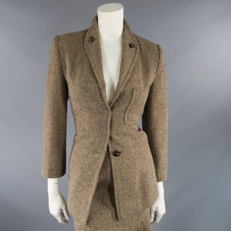This lovely tailored jacket suit by OSCAR DE LA RENTA comes in a beige, taupe, and brown textured tweed and features a diamond shaped lapel that bed lapel with brown buttons, patch breast pocket, and  single button closure with two hook eye closures