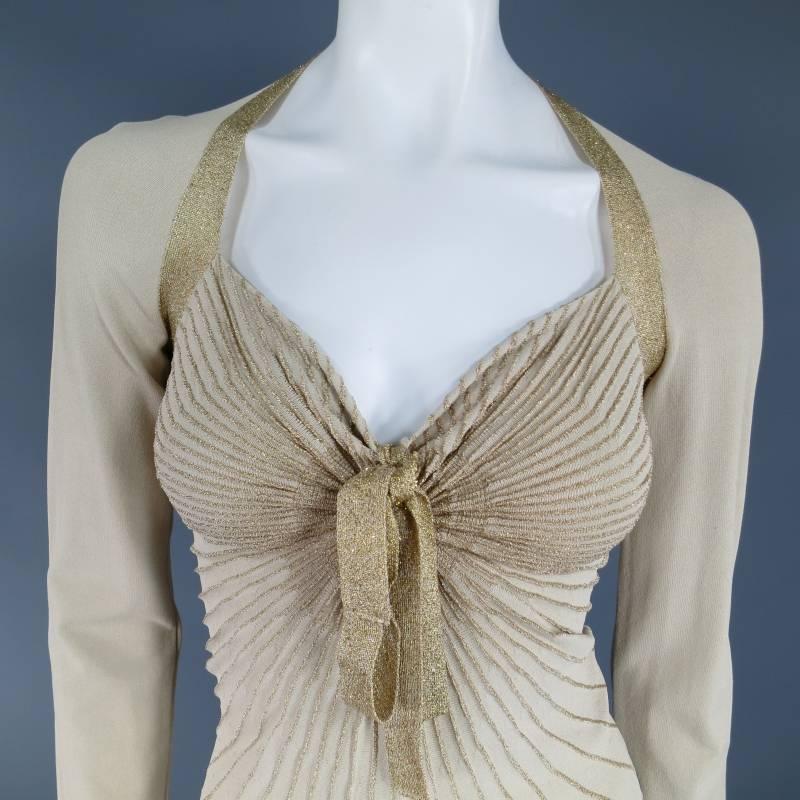 This fabulous VALENTINO top comes in a beige stretch viscose knit and features a sweetheart neckline with tie, metallic gold lurex piping and stripes, and solid long sleeves. Made in Italy.
 
Very Good Pre-Owned Condition.	Marked: M
