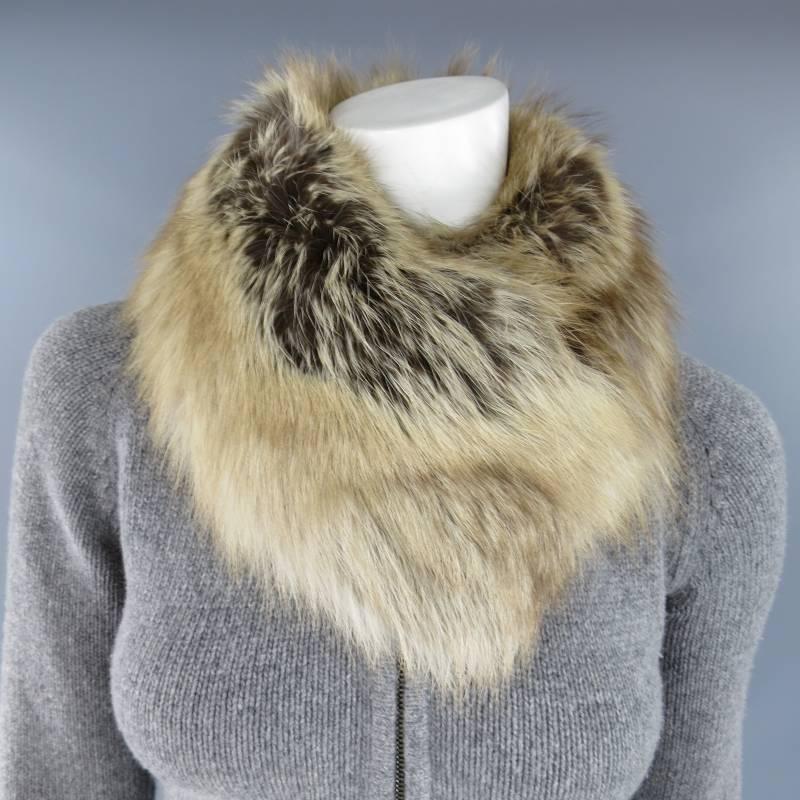 This fabulous PRADA sweater jacket comes in a grey cashmere blend knit and features a zip closure with embossed zipper, belted waist, chocolate brown leather elbow pads, beige fox fur collar with hook and eye closure. Made in Italy.
 
Excellent