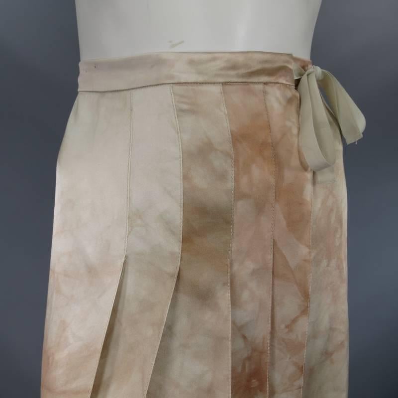 This rare and fabulous wrap skirt by PRADA comes in a beautiful light beige silk satin with unique blush marble dye print throughout and features snap closure with waist tie, frontal box pleat panel, A-line silhouette, and back slit.  Made in