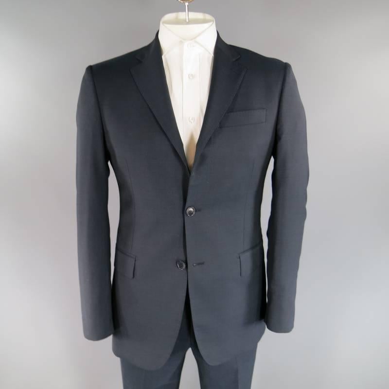 PIERRE BALMAIN Suit consists of wool material in a navy color tone. Designed with a notch lapel collar, 2-button front, silhouette tone-on-tone stitching and front flap pockets. Detailed with a 4-button cuff, double back vent with full lining
