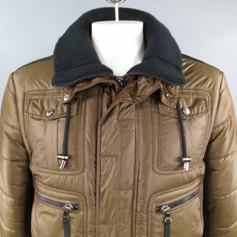 D&G by DOLCE & GABBANA Jacket consists of poliammide material in a brown color tone. Design in a quilted style, zipper front/snap closure, high collar neck with hidden collar and cotton rib fabric. Multi-pocket front with snap and zipper closures.