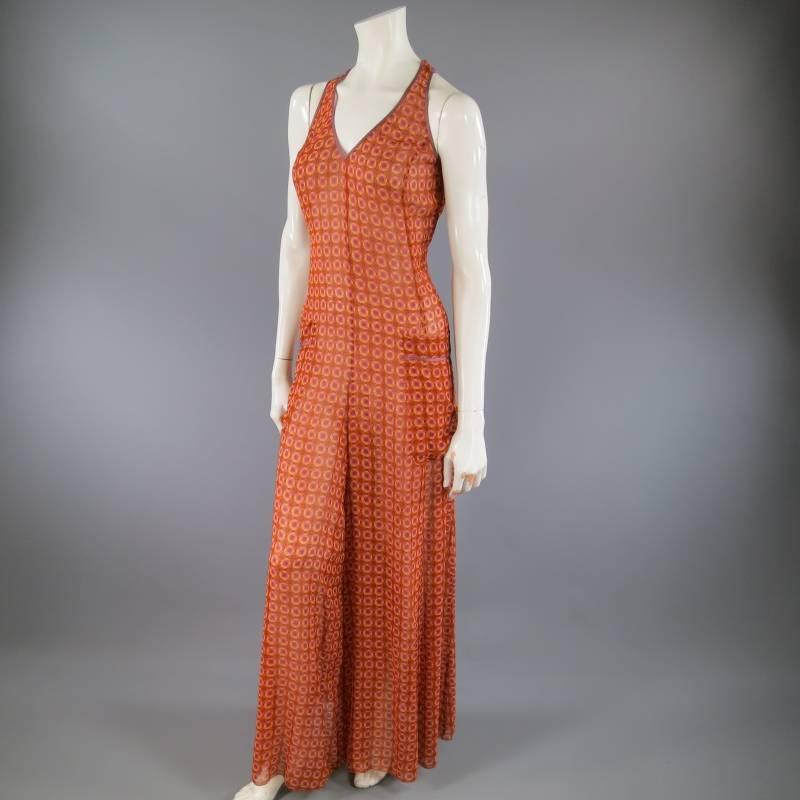 this fabulous MARC JACOBS jumpsuit comes in a sheer orange and purple floral polka dot silk chiffon and features a V neck with lavender piping, racer back, wide legs, and patch pockets.
 
Excellent Pre-Owned Condition.     Marked: 4
